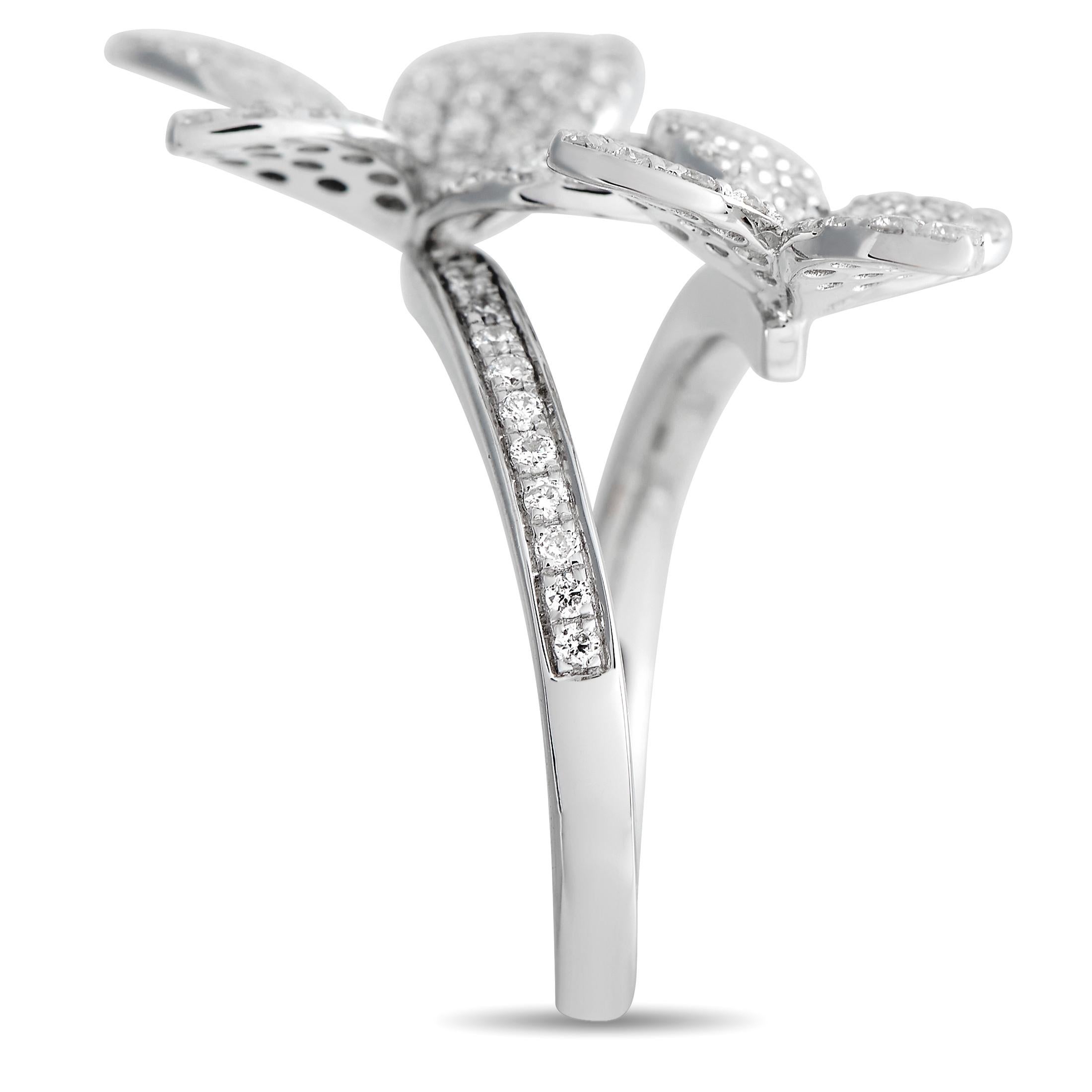 On this luxurious ring, an elegant 18K White Gold setting allows a pair of abstract floral motifs to wind around the finger. This stunning piece of jewelry features a 2mm wide band and a 5mm top height - but it’s the sparkling arrangement of