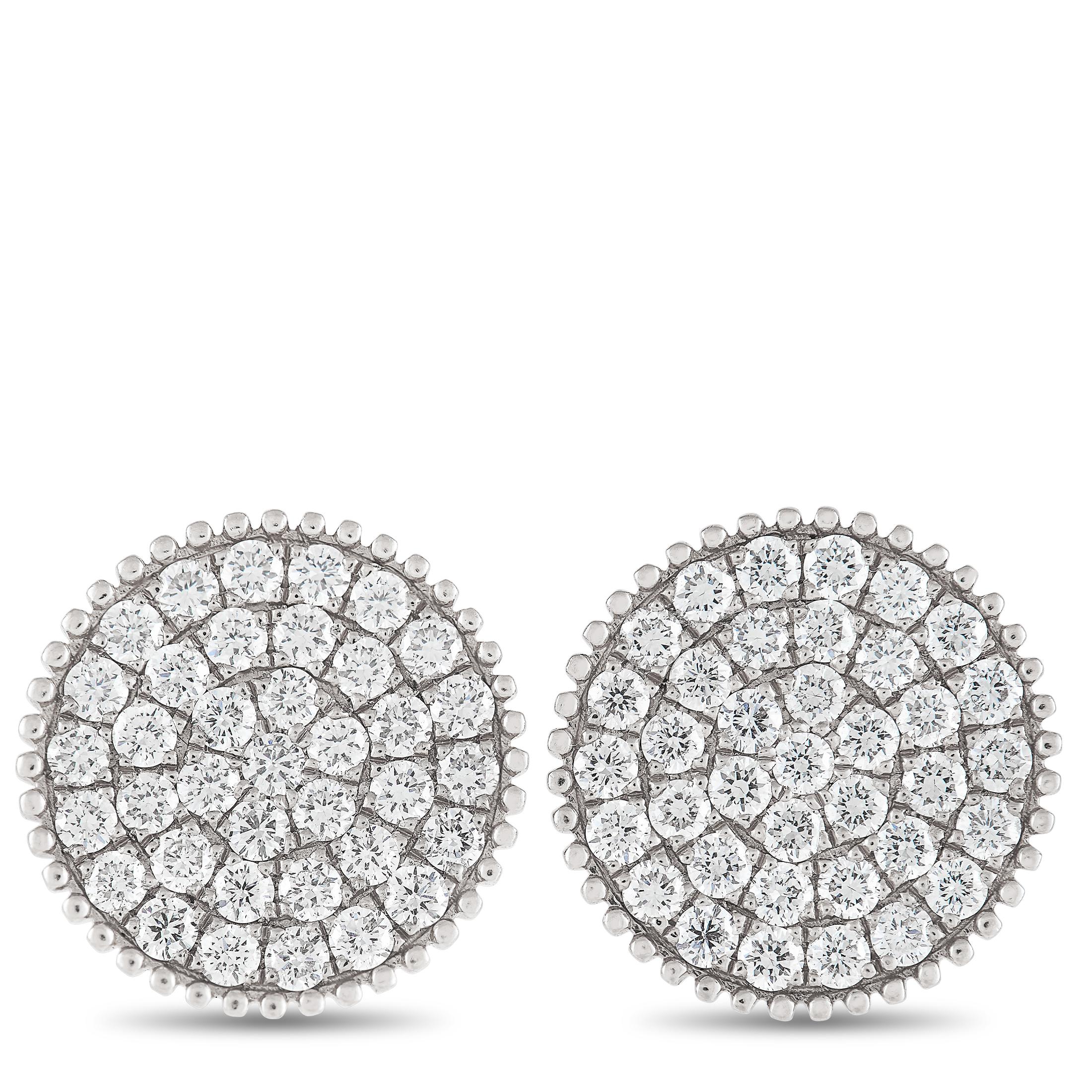 These elegant earrings will continually capture your imagination. Their stunning circular settings are crafted from 18K White Gold and measure 0.50” round. Diamonds with a total weight of 1.30 carats cover the center, while millegrain detailing