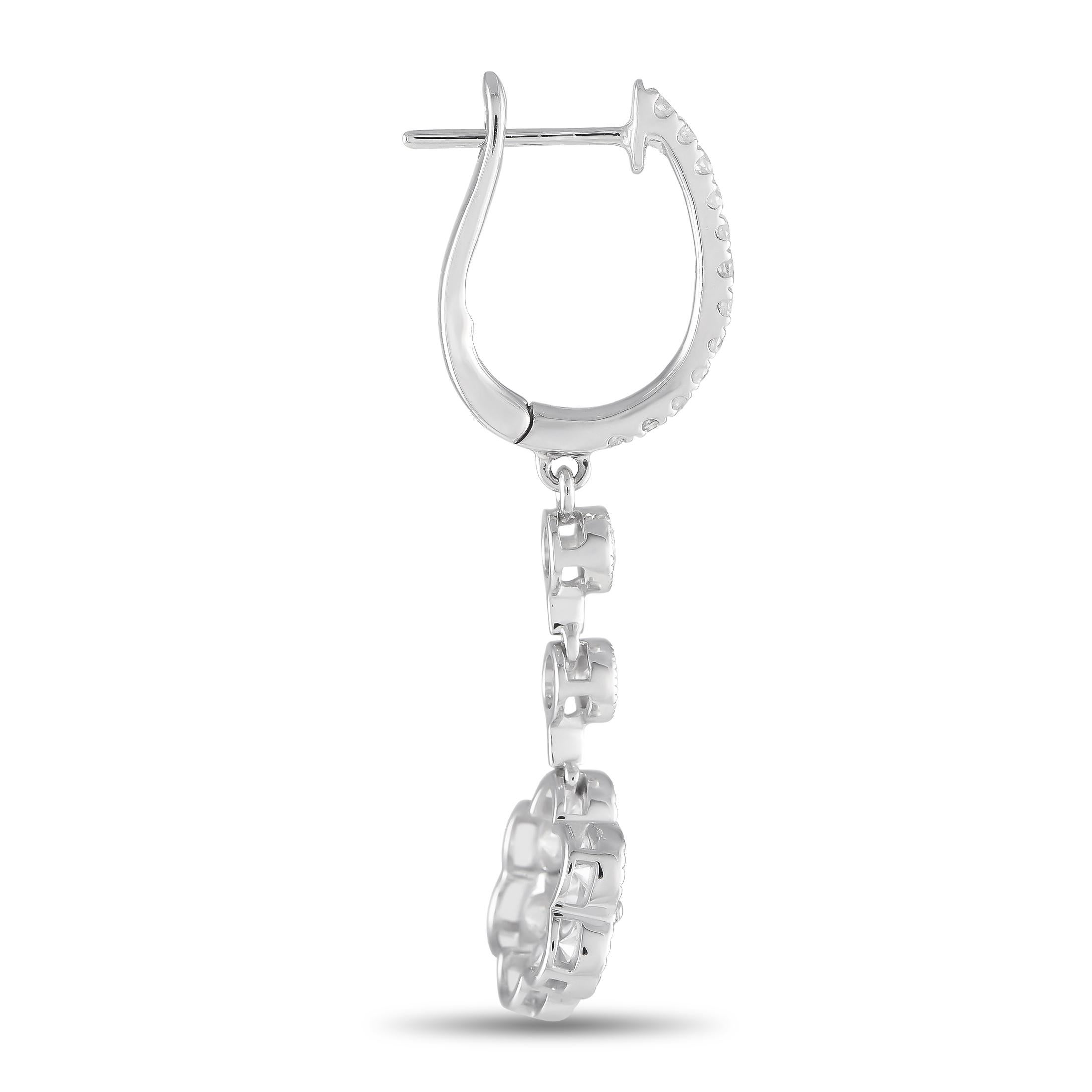 Sparkling Diamonds with a total weight of 1.73 carats and delicate floral motifs make these earrings an elegant addition to any ensemble. Crafted from 18K white gold, each one measures 1.45 long by 0.45 wide.This jewelry piece is offered in brand