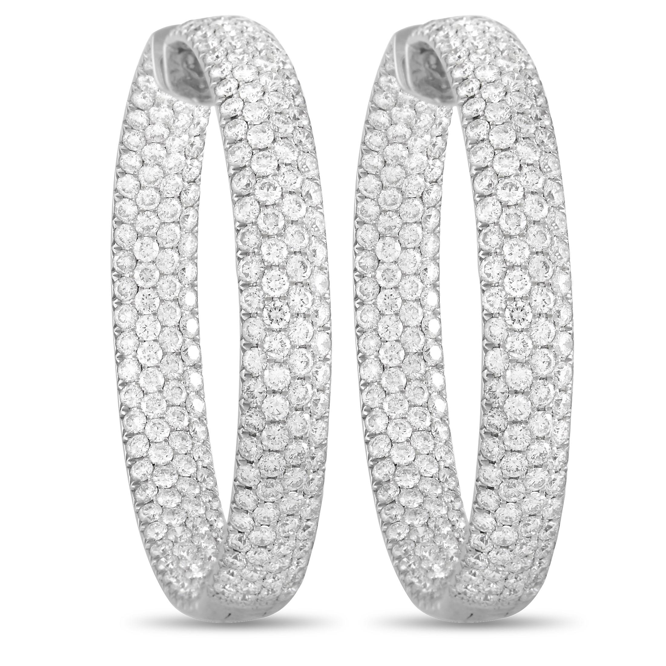 Heads will turn whenever these elegant hoop earrings enter a room. Crafted from 18K White Gold, the breathtaking array of diamonds totaling 17.75 carats allows them to effortlessly radiate light. Each one measures 1.75” round and will ensure you