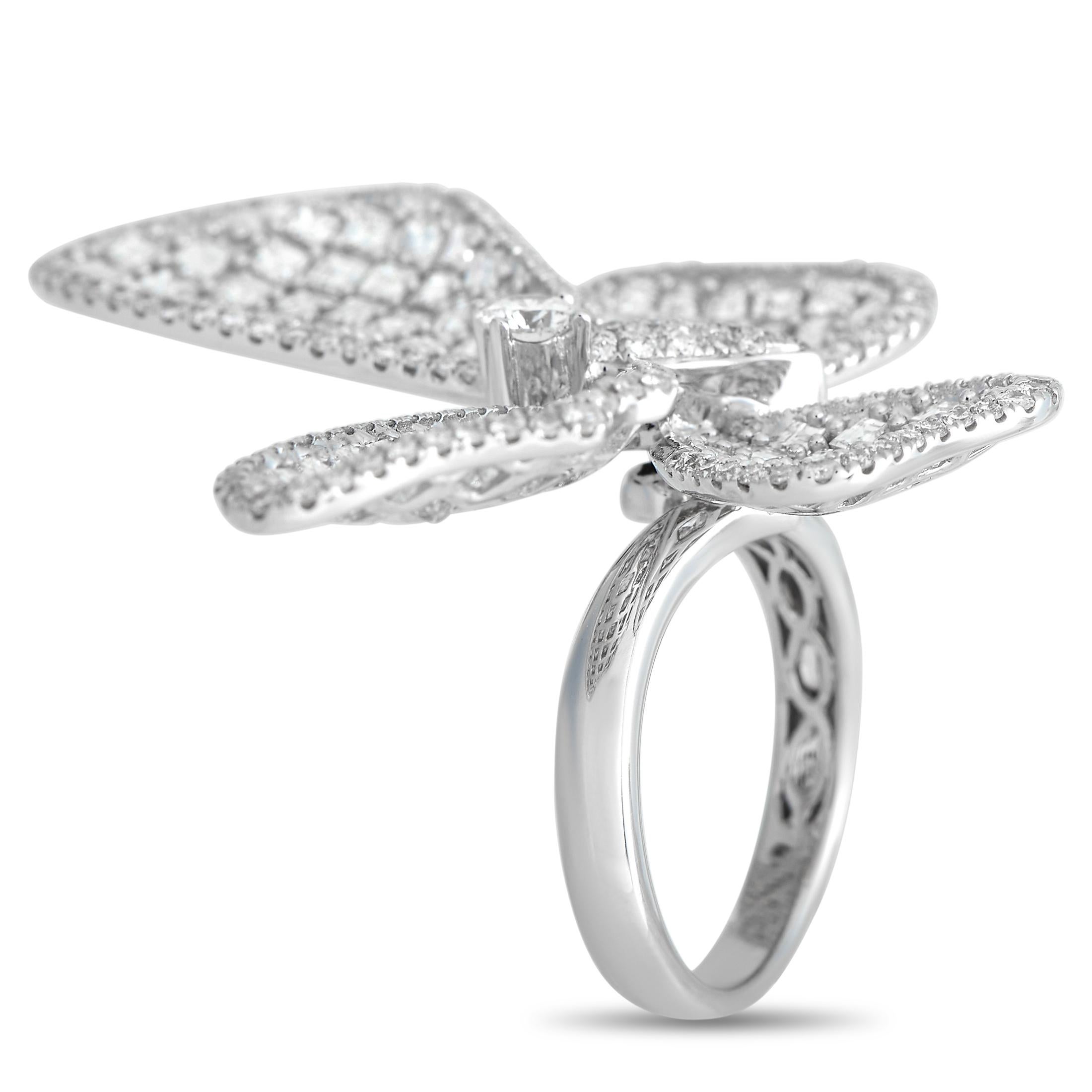 This stunner is a real showstopper. It has a sleek 3mm band in 18K white gold, with textured shoulders and a subtle bypass style. The ring is topped with an oversized, diamond-encrusted butterfly centerpiece that glitters non-stop. A larger round