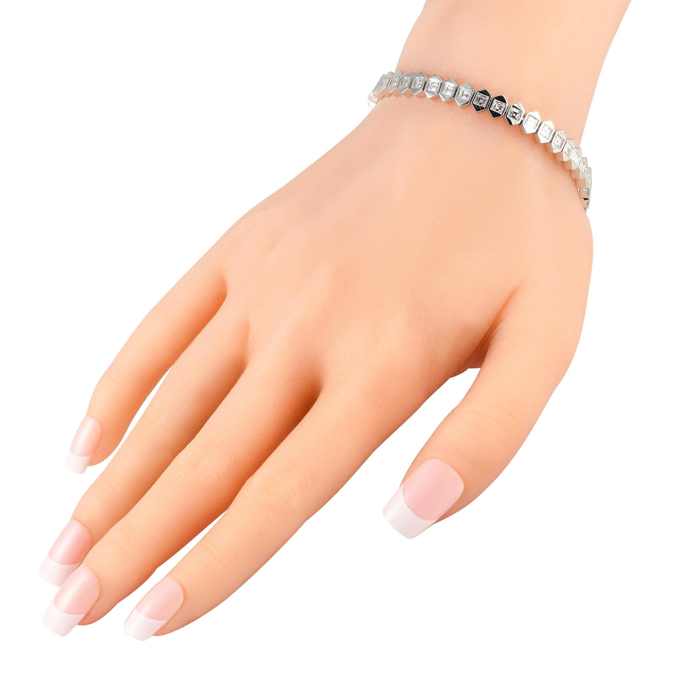 Designed to look both edgy and chic, this geometric bracelet would make a fantastic addition to any outfit. It is fashioned in solid 18K white gold, with a series of elongated hexagonal tiles that form an unbroken row. Each six-sided tile carries a