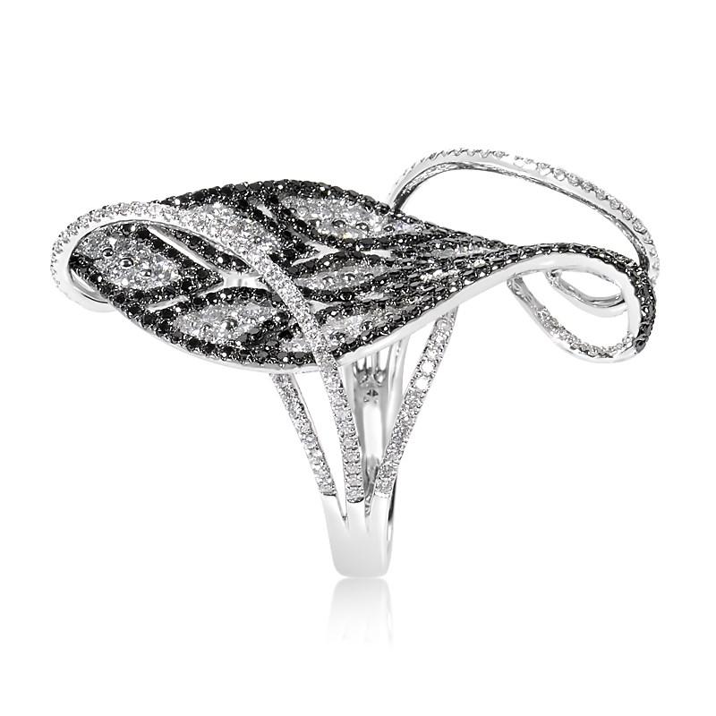 This gorgeous ring has a dramatic design that shines with a rare and sumptuous beauty. The ring is made of 18K white gold and features a lavish design set with ~2.54ct of black and white diamonds.
