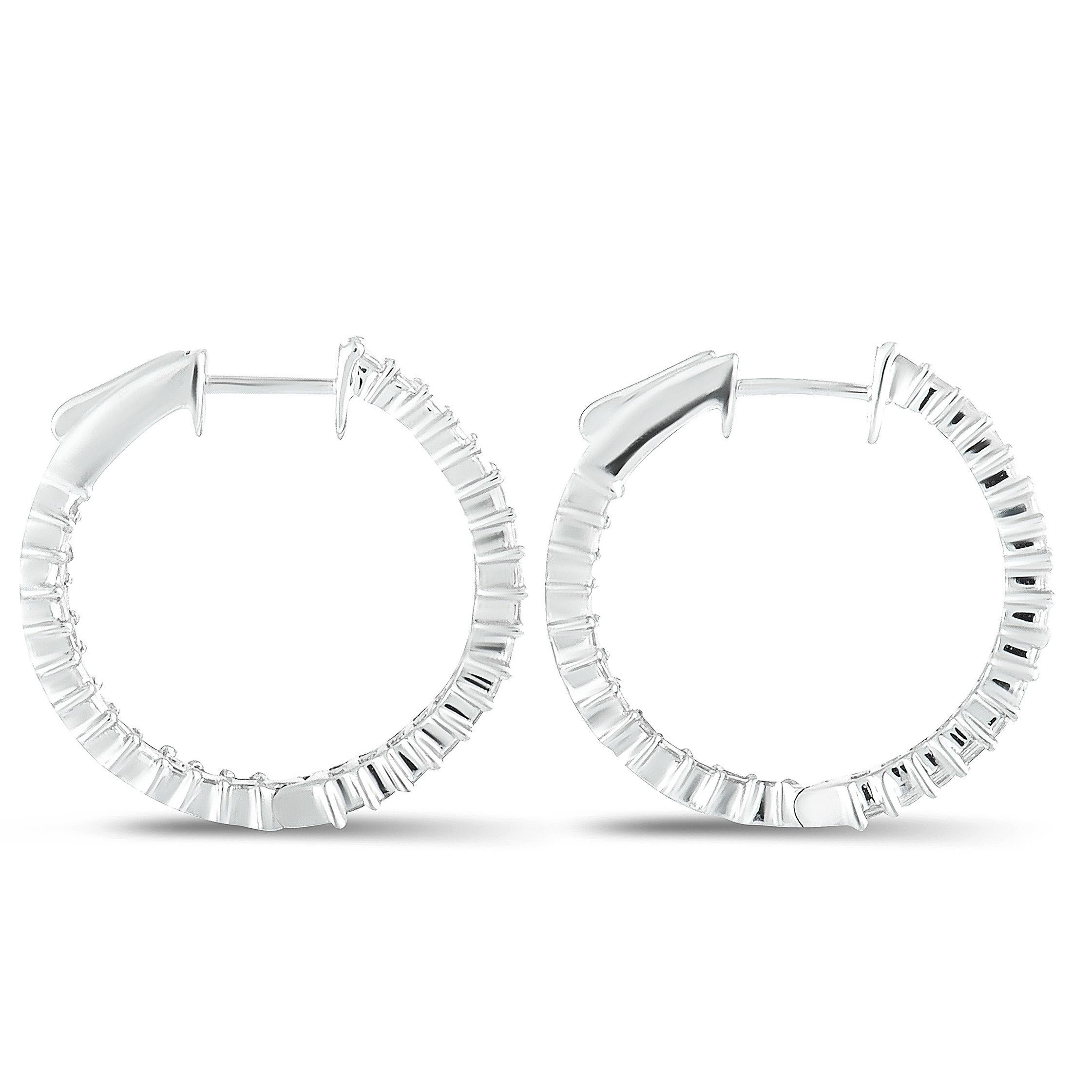 Embodying the very essence of refined extravagance, these sublime hoop earrings boast a stunningly luxurious appeal that will give a sublime touch of prestigious elegance to any ensemble of yours. The earrings are  crafted from gleaming 18K white