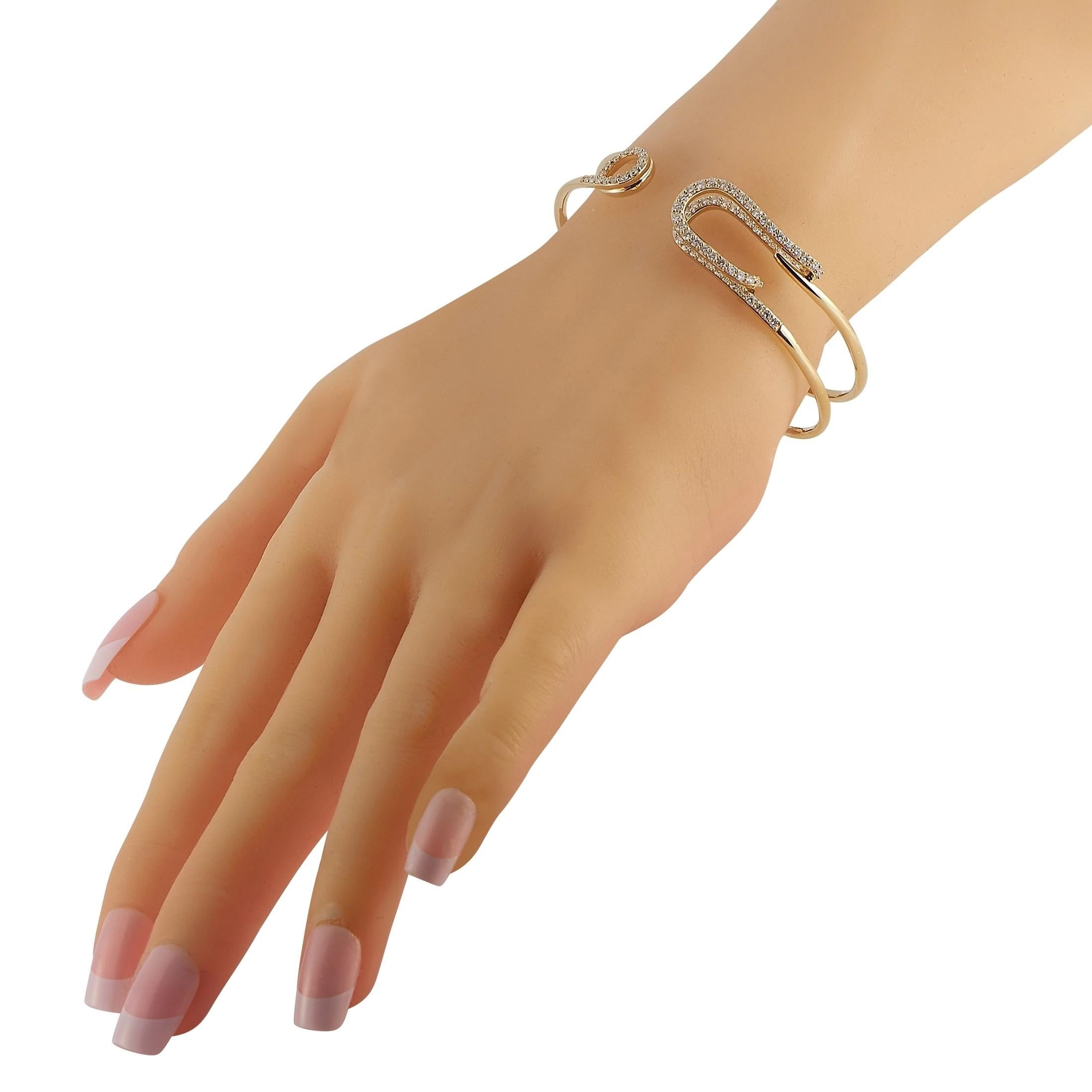Add charm to any outfit with this fun, fabulous bracelet. An 18K Yellow Gold setting resembles a safety pin, which adds a unique sense of charm. It measures 7.5” long and comes complete with inset diamonds totaling 1.52 carats. 
 
 This jewelry