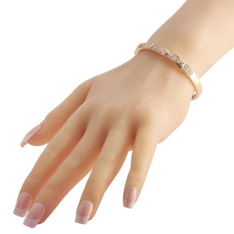 The contemporary design details of this yellow gold bangle can add sophistication to both day and evening looks. The 7-inch bracelet features 1.12 carats of round diamonds arranged in triple rows, alternating with 1.64 carats of fancy diamonds in