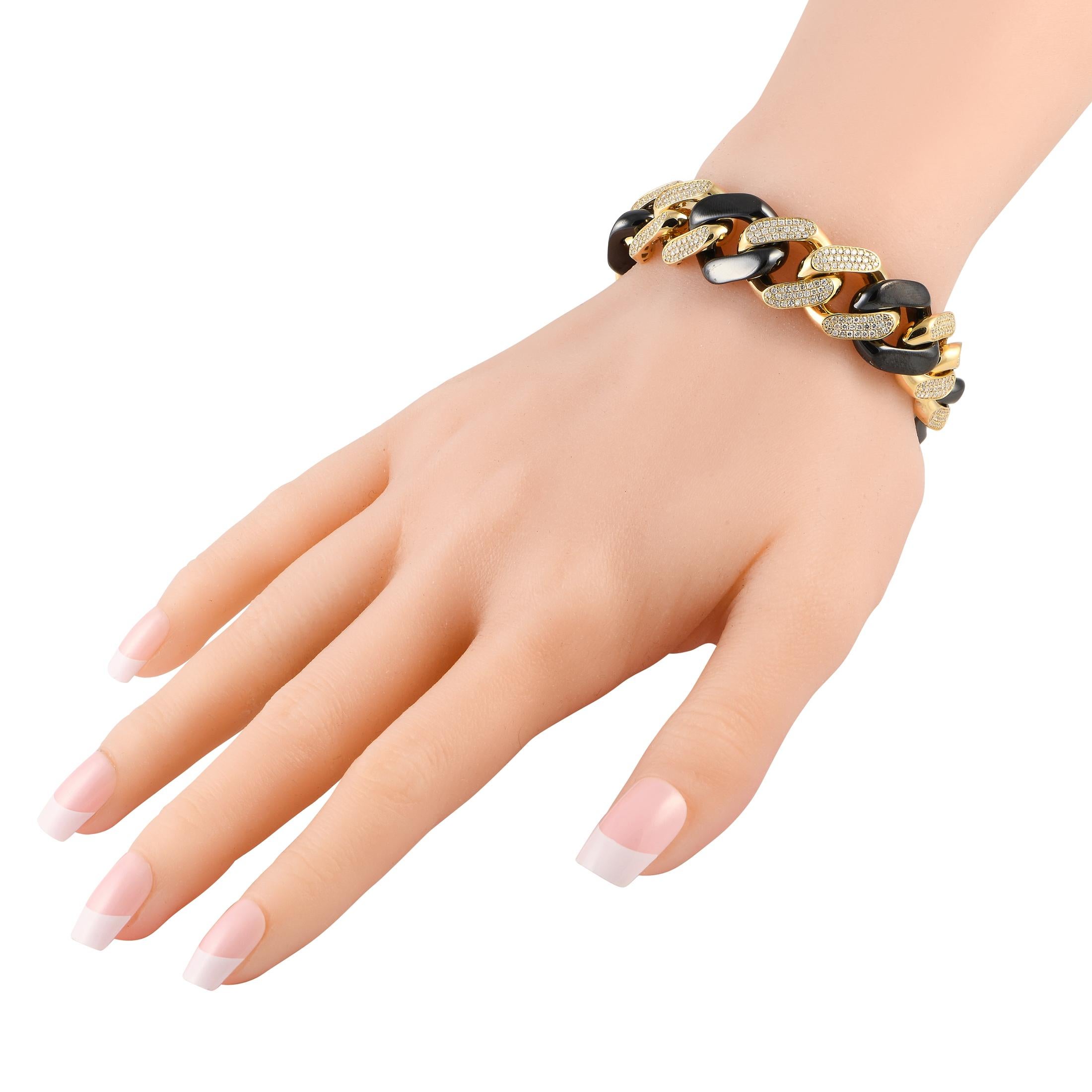 Give depth to your style with this chunky and heavy chain bracelet. It features duos of diamond-paved yellow-gold links interlocking with black-colored chain links. Diamonds totaling 5.00 carats make this bracelet truly impressive. 

This brand new