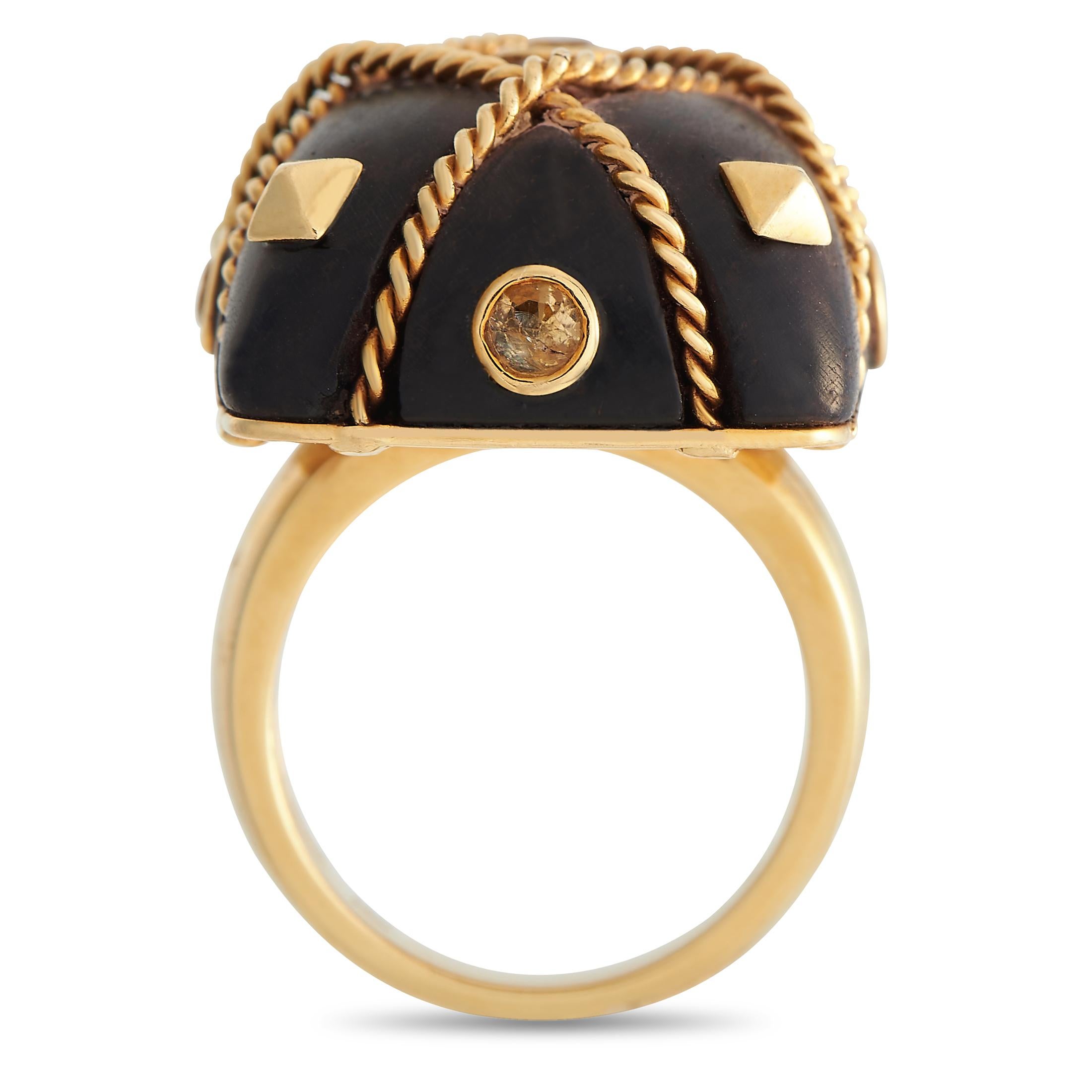 A fine finishing touch to your bohemian wardrobe. This ring features a 5mm thick band fashioned in 18K yellow gold. It is topped with a chunk of wood with rounded corners, secured in place by rope-like strings of yellow gold.  Bezel-set yellow