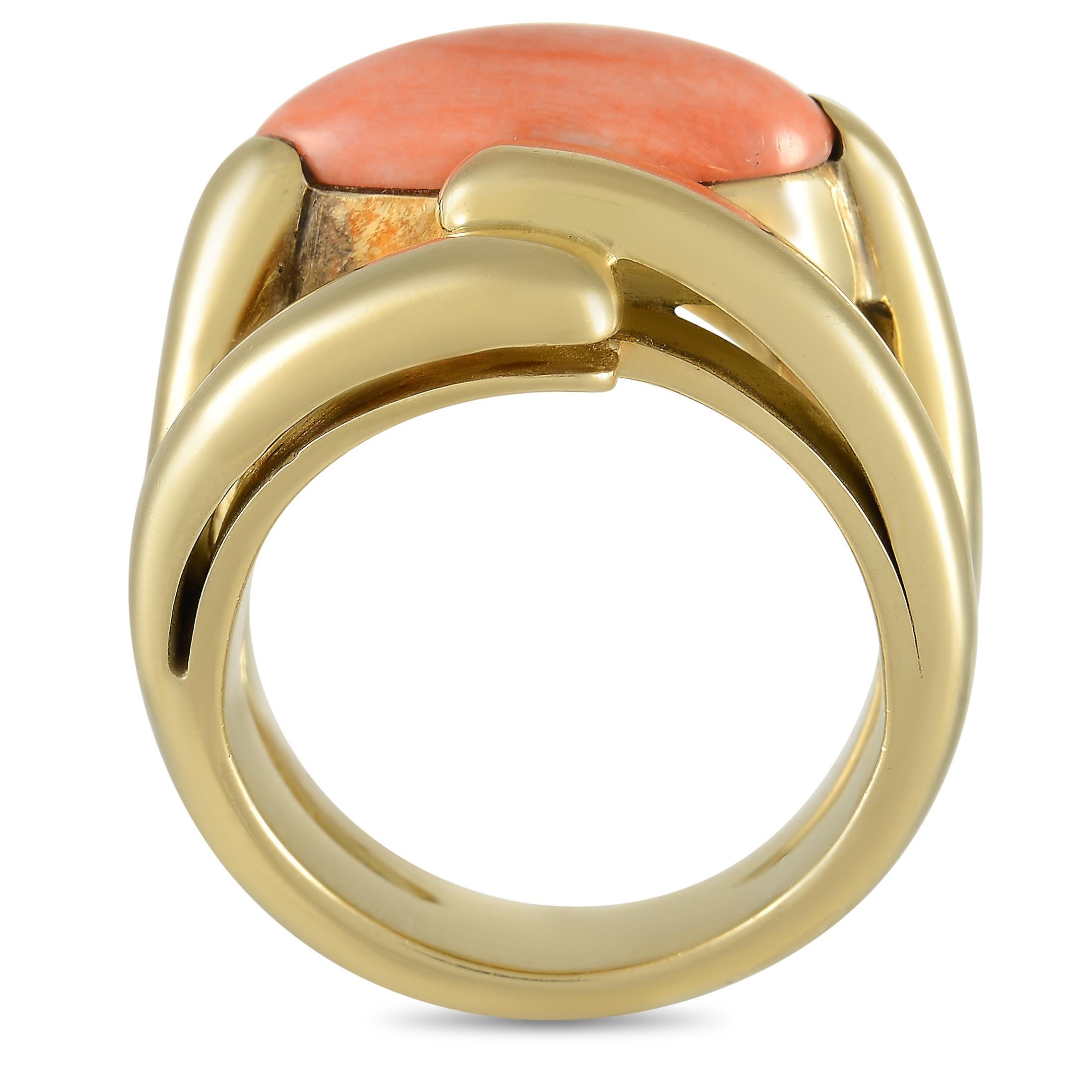 A stylish setting crafted from 18K yellow gold provides the perfect foundation for this dynamic luxury ring. Bold and elegant, this piece features a 12.5mm wide band and a 10mm top height. At the center, you’ll find a captivating coral gemstone that