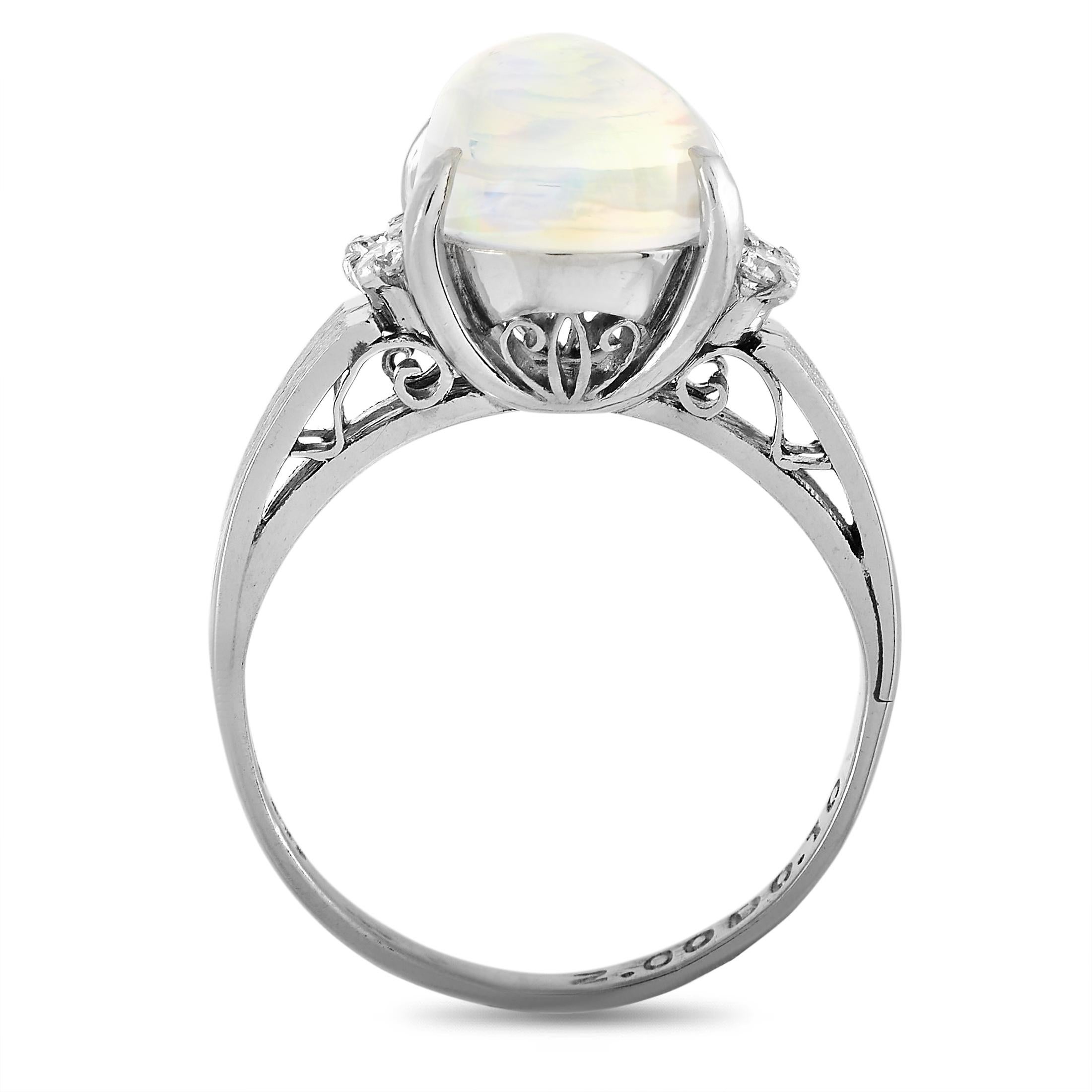 This LB Exclusive ring is crafted from platinum and weighs 4.1 grams, boasting band thickness of 2 mm and top height of 10 mm, while top dimensions measure 10 by 12 mm. The ring is set with a 2.00 ct opal and a total of 0.10 carats of diamonds.
 

