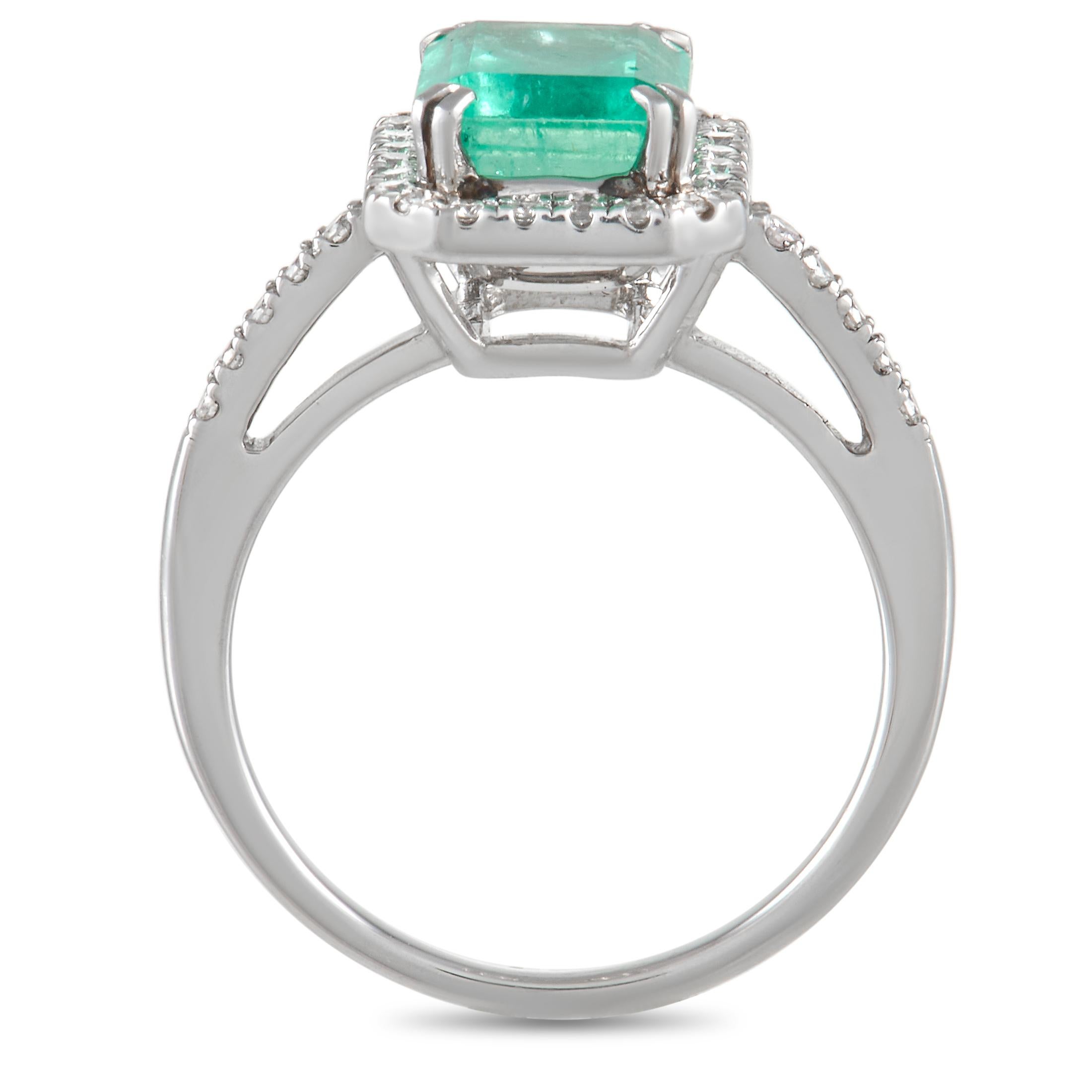 Giving off elegant vibes is this enviable emerald and diamond ring. Fashioned from platinum is a slender 1mm band adorned with a light green emerald-cut emerald stone embraced by an emerald-shaped halo of white diamonds. More diamonds flank the