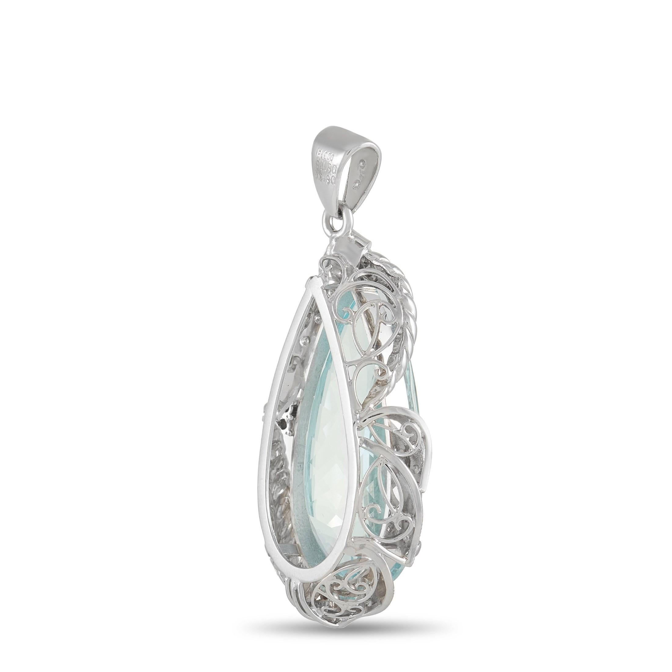 Luxurious and opulent in design, this incredible pendant is ready to serve as a breathtaking addition to any jewelry collection. At the center of this pendant - which measures .88” wide and 1.76” long - sits a captivating light blue 34.80 carat