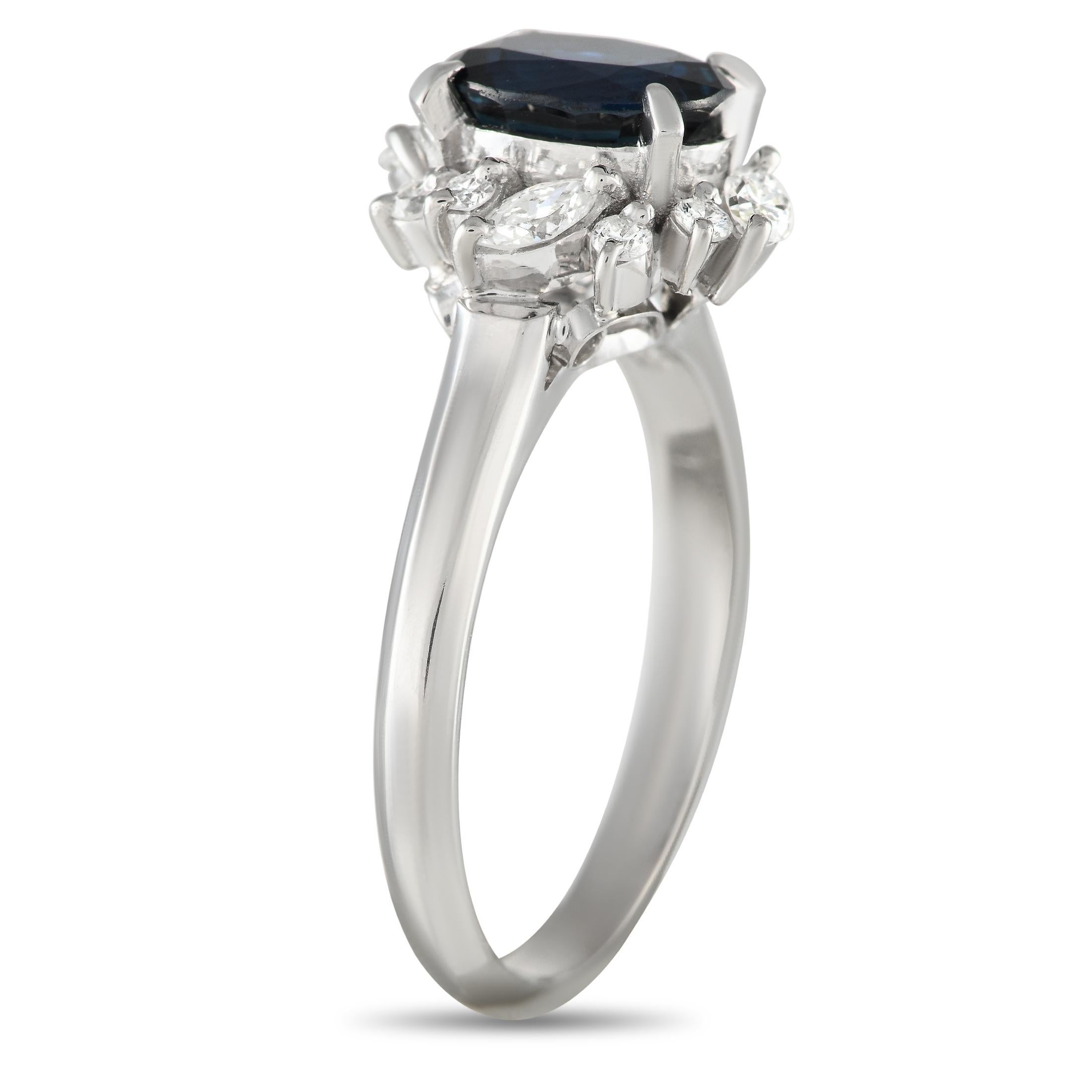 Sure to steal her heart is this elegant diamond and sapphire ring with just the perfect hint of edginess. It features a 2mm-thin platinum band holding a majestic 1.52-carat sapphire center stone. The glittering halo, composed of round and marquise