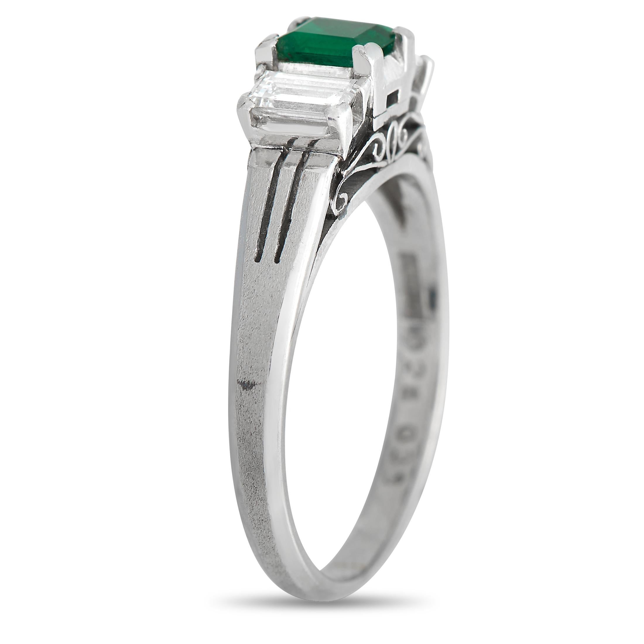 A breathtaking 0.28 carat Emerald center stone makes a statement at the center of this exquisite ring. Surrounded by two baguette-cut diamonds with a total weight of 0.39 carats, this impressive accessory is impossible to ignore. Crafted from