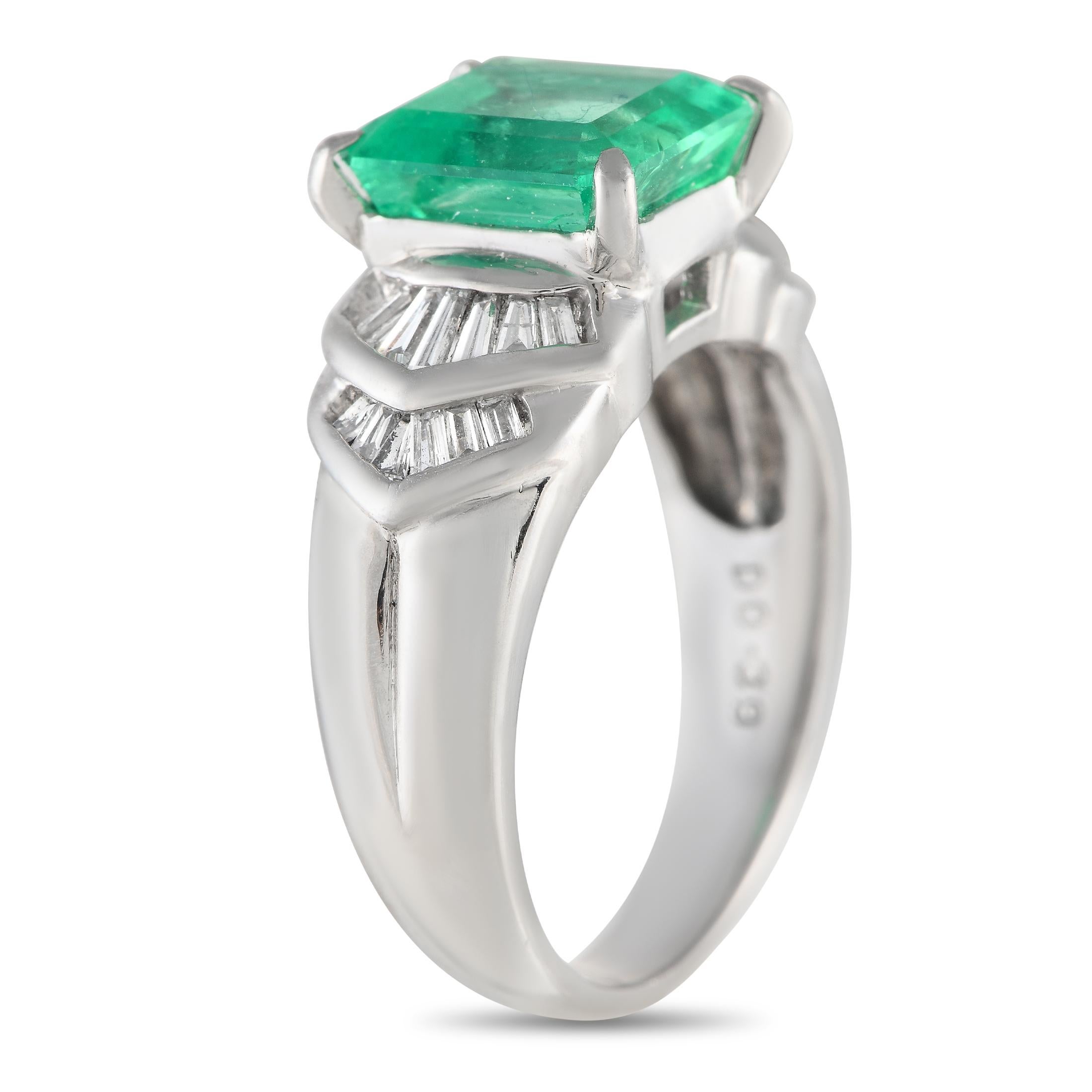 Wear the May birthstone proud with this diamond and emerald wide band ring. It features a 4mm platinum band that widens on top to accommodate a large emerald central stone flanked by a double chevron pattern of tapered step-cut diamonds. The ring