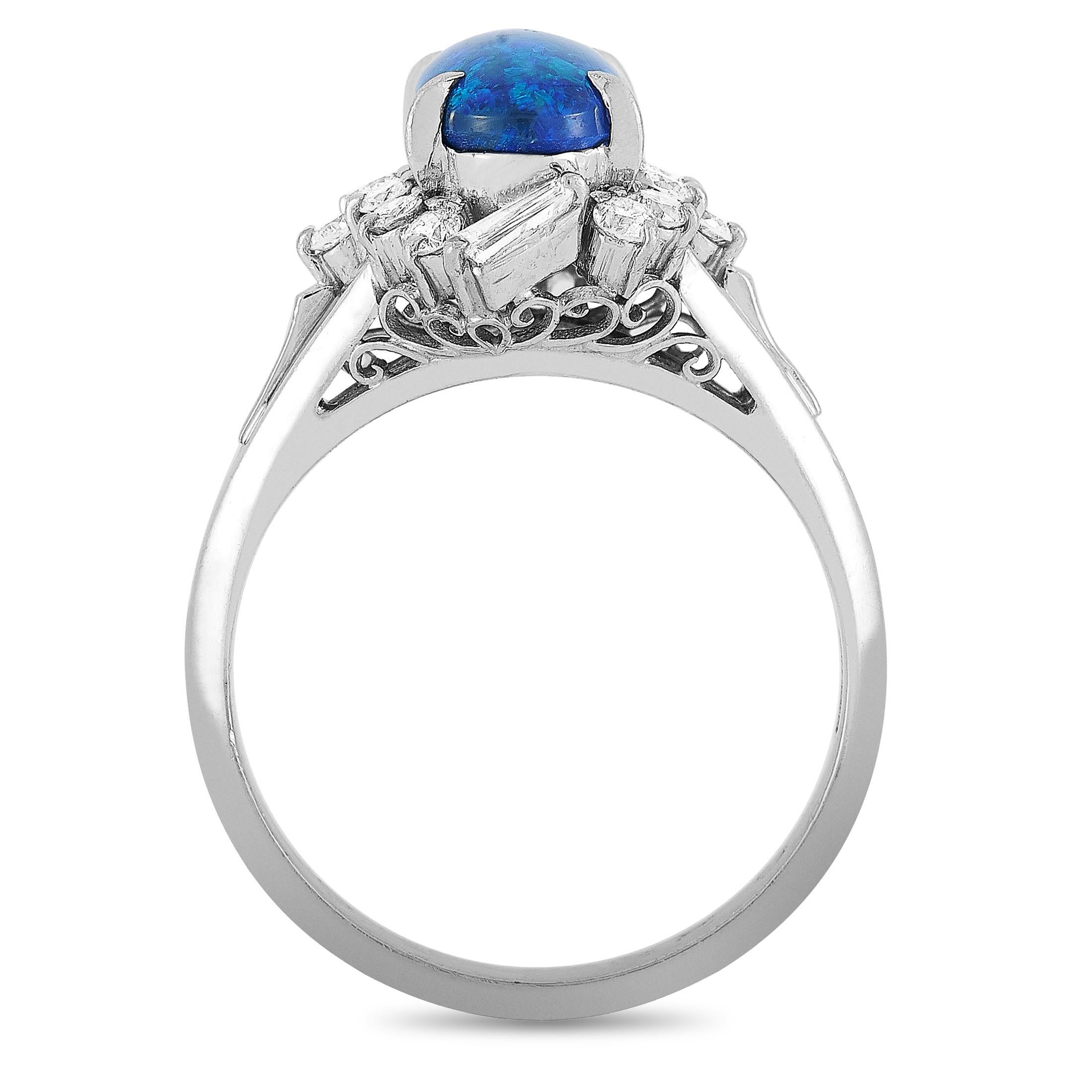 This LB Exclusive ring is crafted from platinum and weighs 6 grams. It boasts band thickness of 3 mm and top height of 8 mm, while top dimensions measure 11 by 13 mm. The ring is set with a 1.33 ct opal and a total of 0.42 carats of diamonds.
Ring