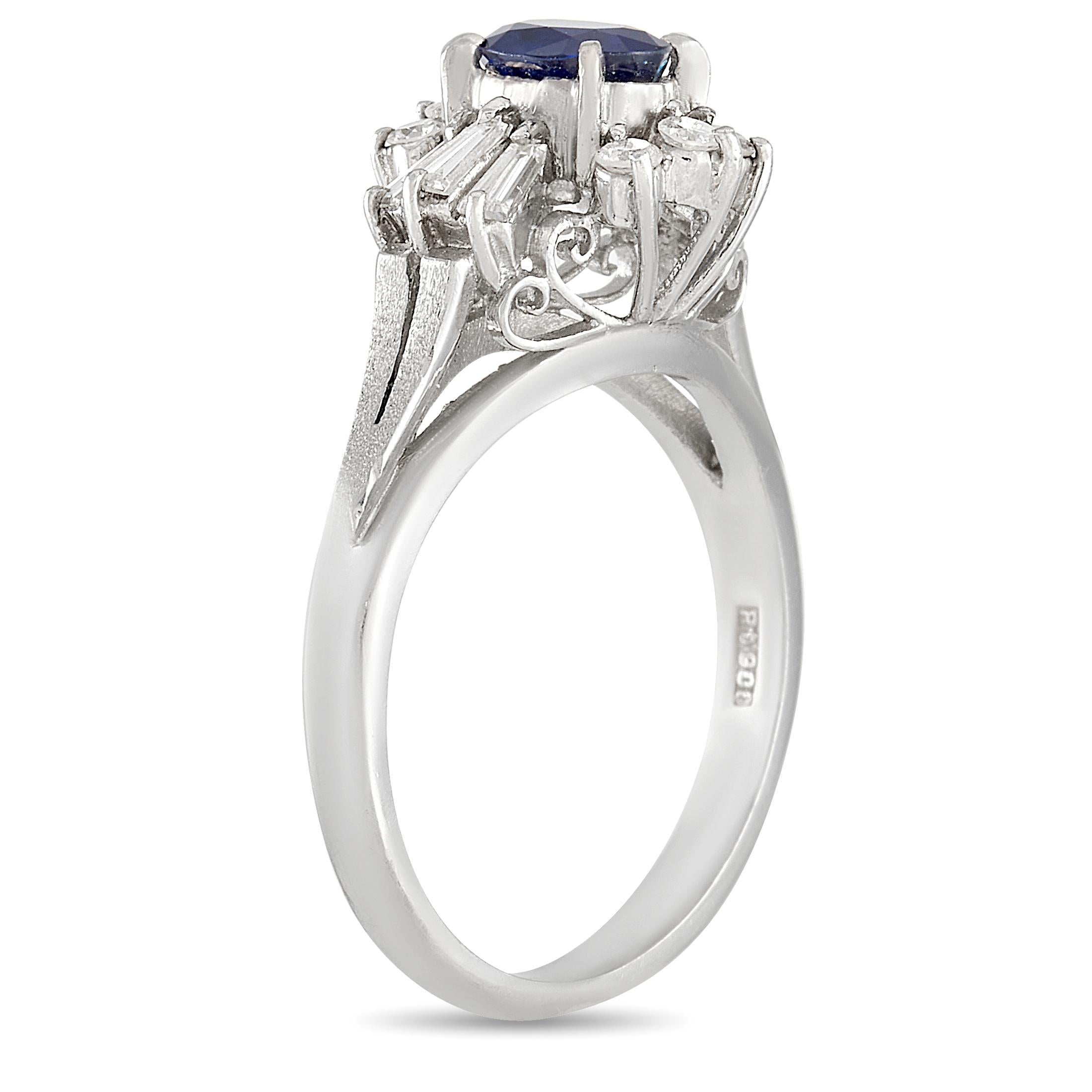 Equal parts classic and contemporary, this luxury Platinum ring has an undeniable elegance. It features a breathtaking oval-cut 0.76 carat sapphire surrounded by a sunburst halo of diamonds totaling 0.45 carats. It features a dainty 2mm band and an