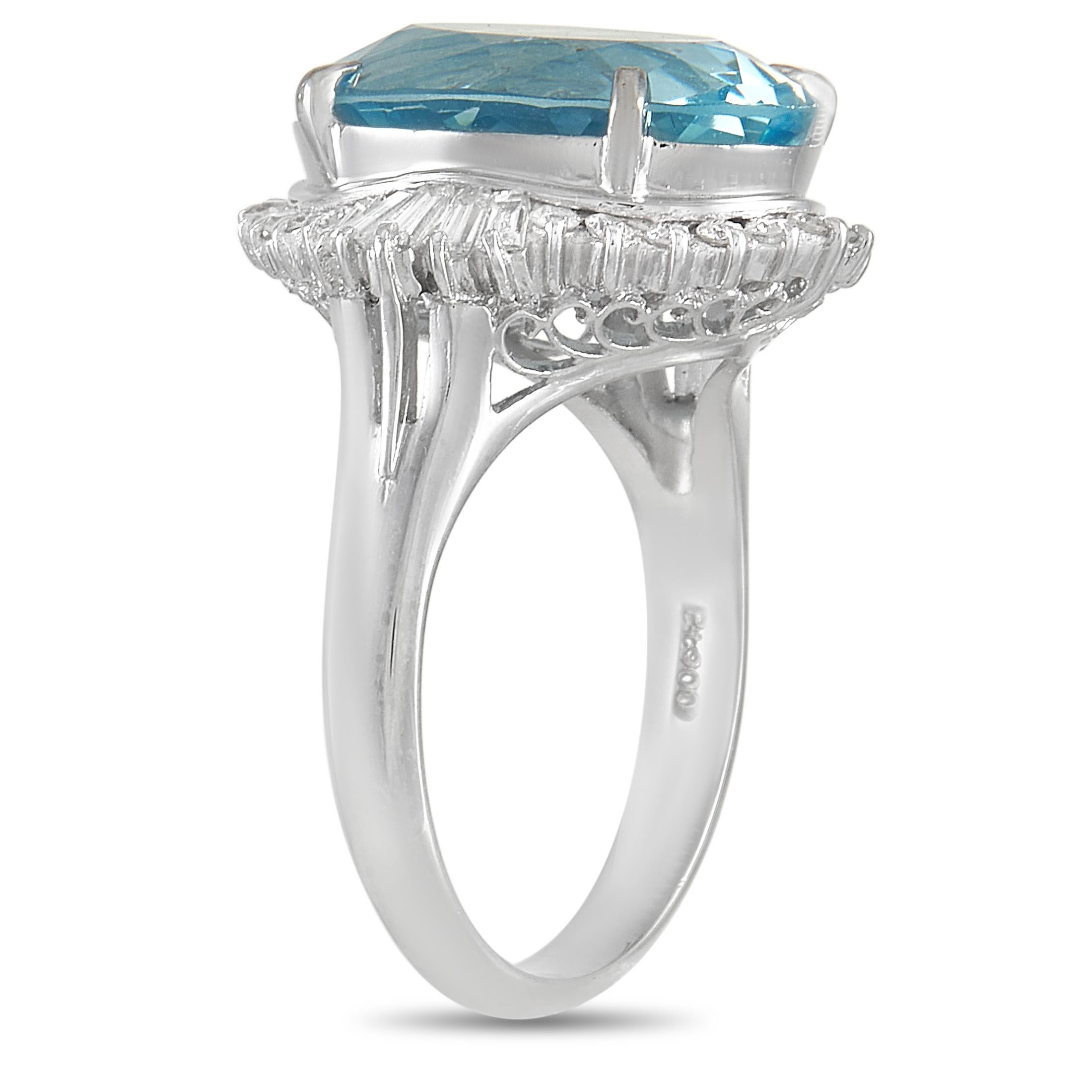 A captivating blue center stone makes this radiant ring simply unforgettable. A shimmering platinum setting adorned with intricate metalwork provides the perfect backdrop for the bright 6.40 carat aquamarine gemstone. A halo of diamonds totaling