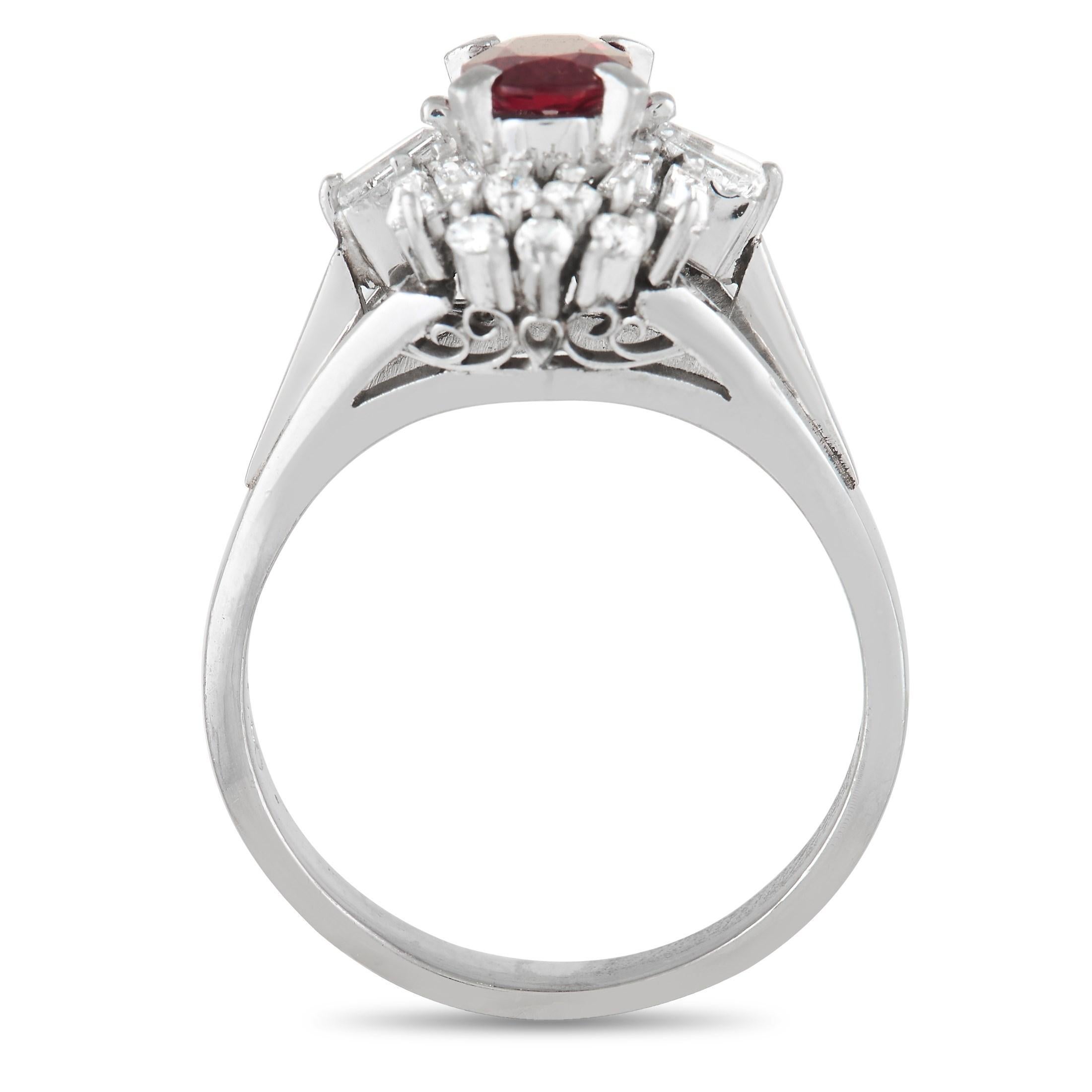 A deep red 0.68 carat ruby gemstone provides a captivating focal point at the center of this impeccably designed ring. Along with a shimmering platinum setting, this radiant design also includes a creative arrangement of diamonds that possess a