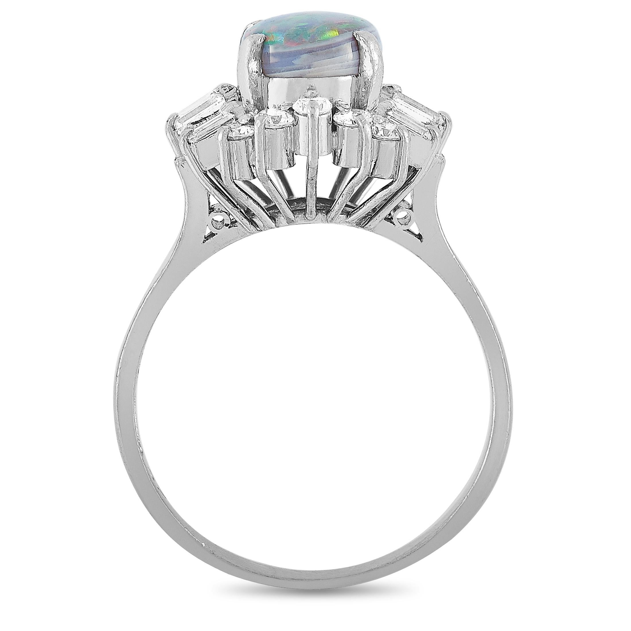 This LB Exclusive ring is crafted from platinum and weighs 5.9 grams. It boasts band thickness of 2 mm and top height of 10 mm, while top dimensions measure 14 by 13 mm. The ring is set with a 1.37 ct opal and a total of 0.57 carats of