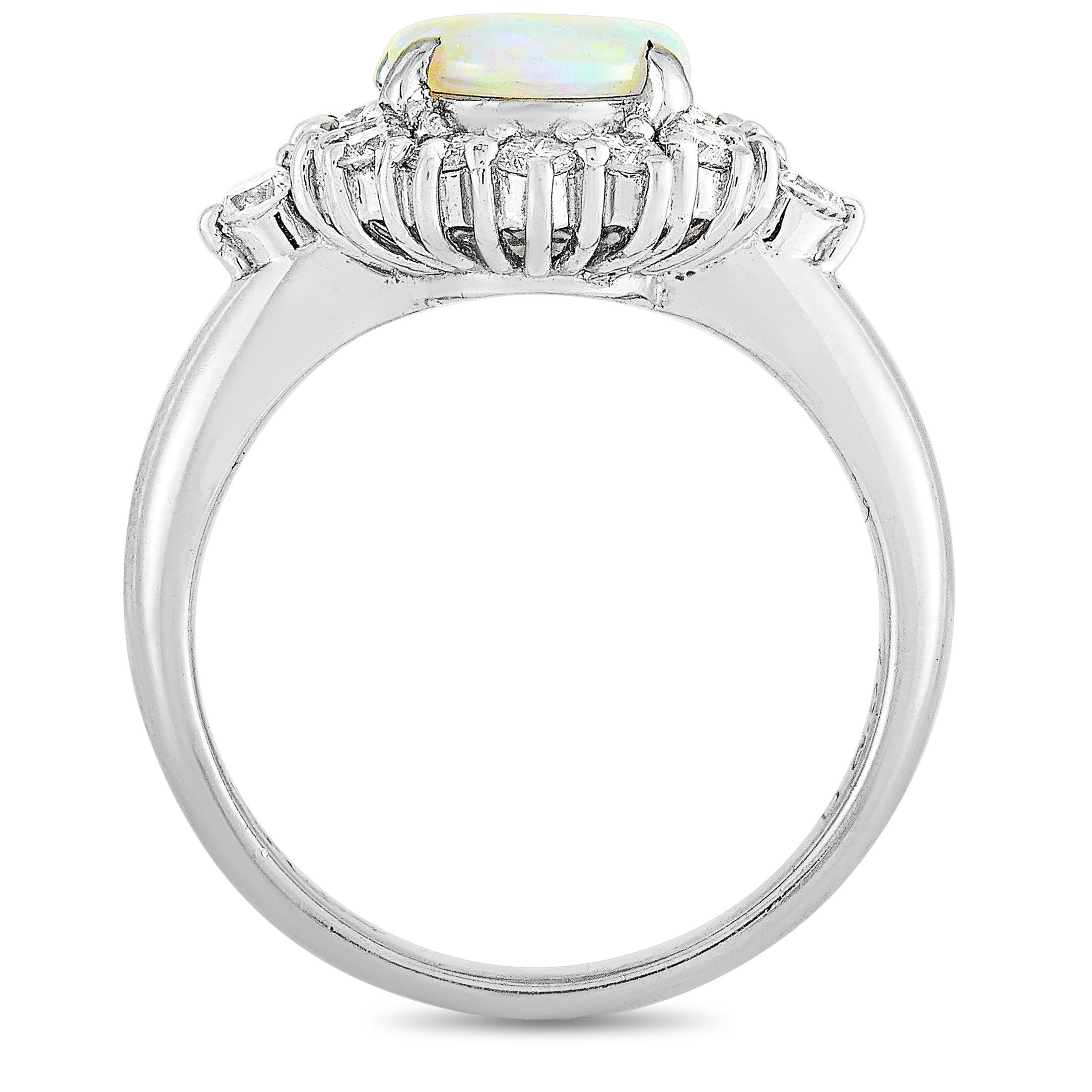 This LB Exclusive ring is crafted from platinum and weighs 5.8 grams. It boasts band thickness of 2 mm and top height of 6 mm, while top dimensions measure 15 by 12 mm. The ring is set with an opal that weighs 0.94 carats and with diamonds that