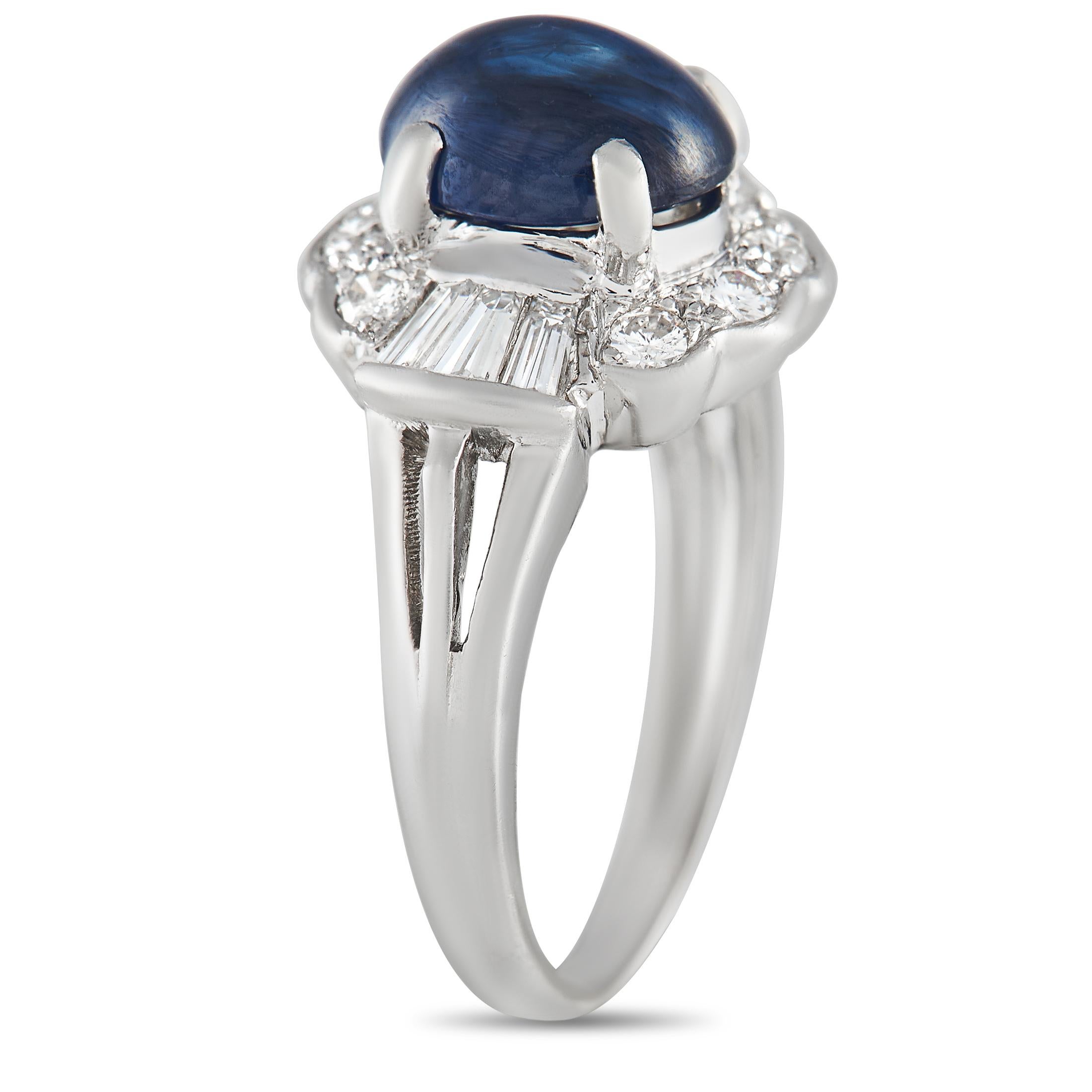A diamond and sapphire ring to satisfy someone with a discerning taste. This platinum ring features a 2.51 ct sapphire cabochon sitting at the center of a stylized frame of diamonds. The blue gem features a domed profile complemented by the