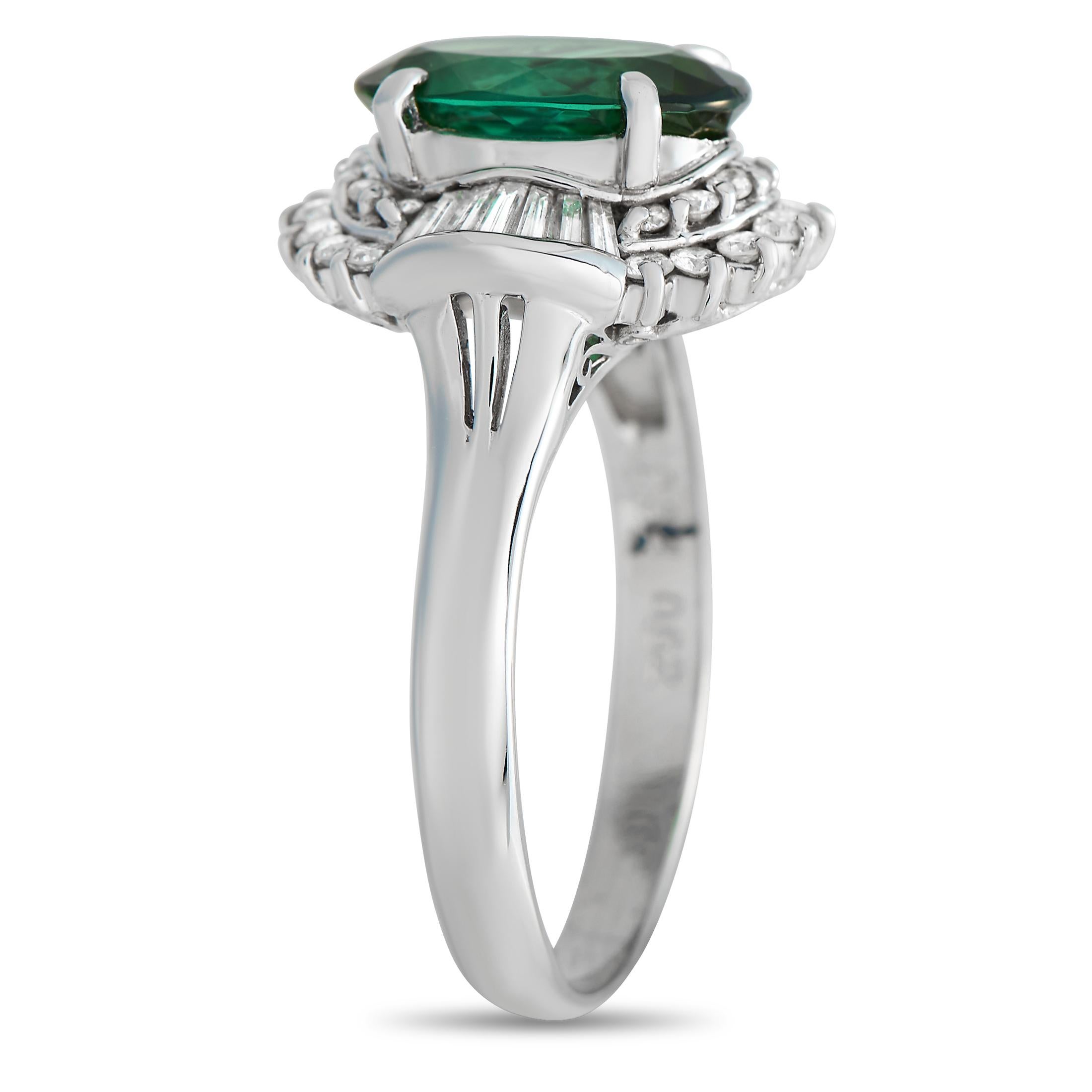 A radiant green 2.34 carat Tourmaline gemstone makes a statement at the center of this ring’s breathtaking Platinum setting, which features a 2mm wide band and an 8mm top height. It’s also surrounded by a dynamic halo of diamonds, which together