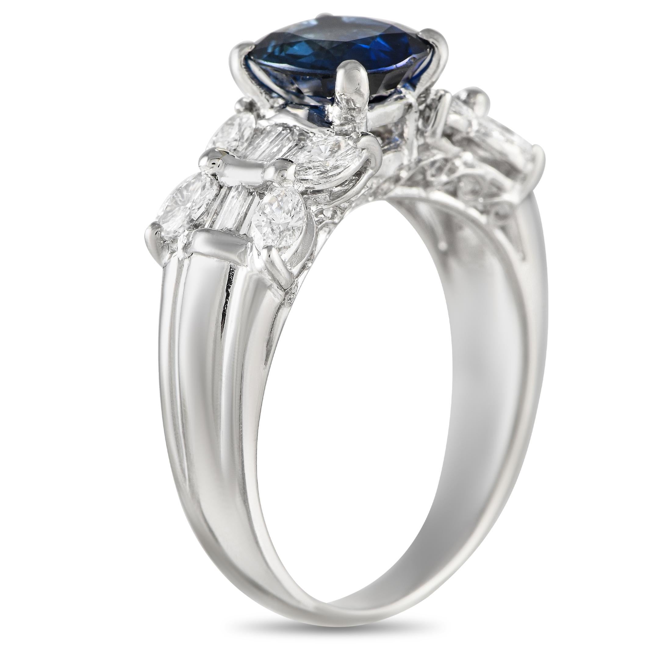 This luxurious ring will continually make a statement. Crafted from pure Platinum, this piece features a 1.69 carat Sapphire center stone surrounded by sparkling Diamonds with a total weight of 0.73 carats. It features a 4mm wide band and a top