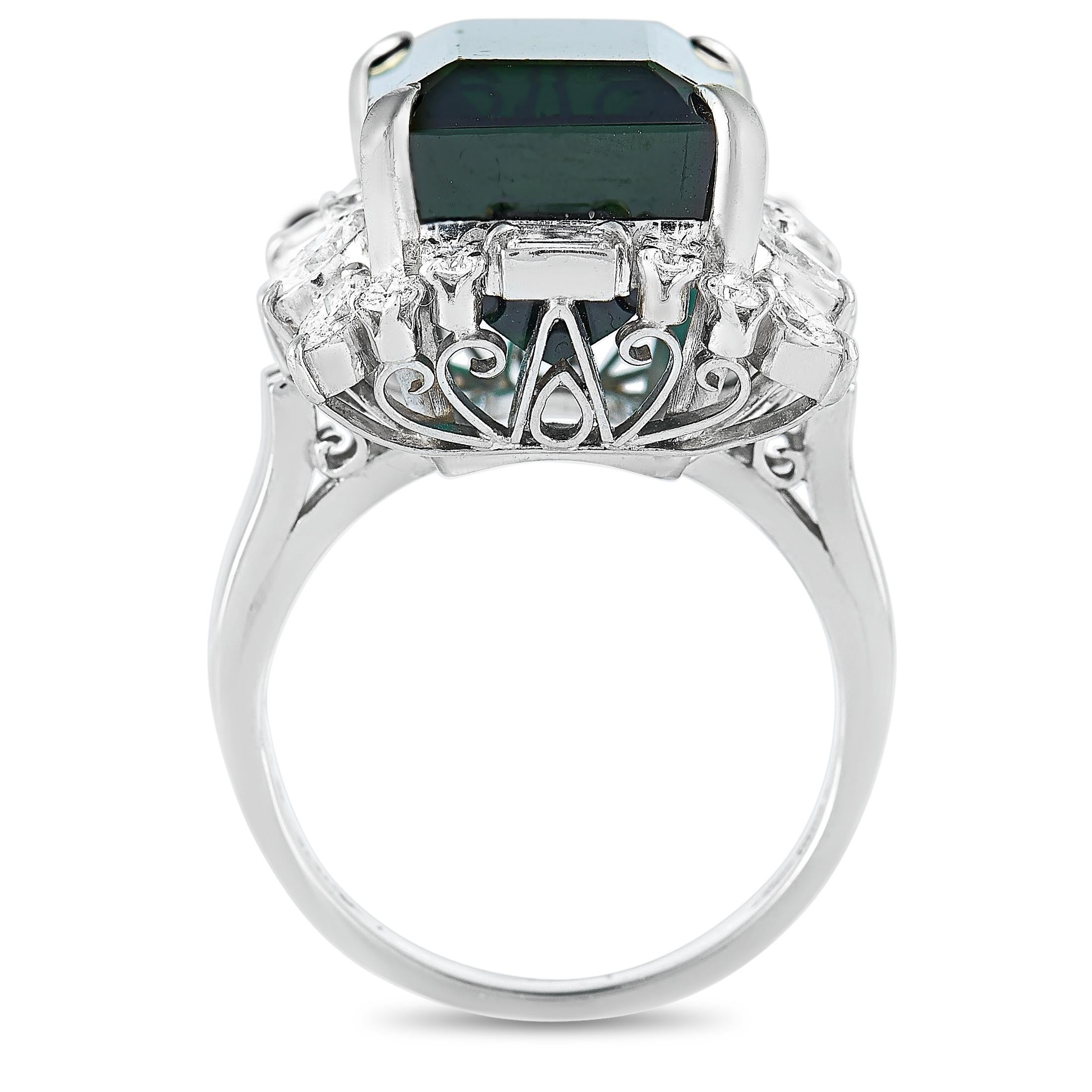 This LB Exclusive ring is crafted from platinum and weighs 15.3 grams. It boasts band thickness of 3 mm and top height of 17 mm, while top dimensions measure 18 by 19 mm. The ring is set with a 16.80 ct green tourmaline and a total of 1.05 carats of