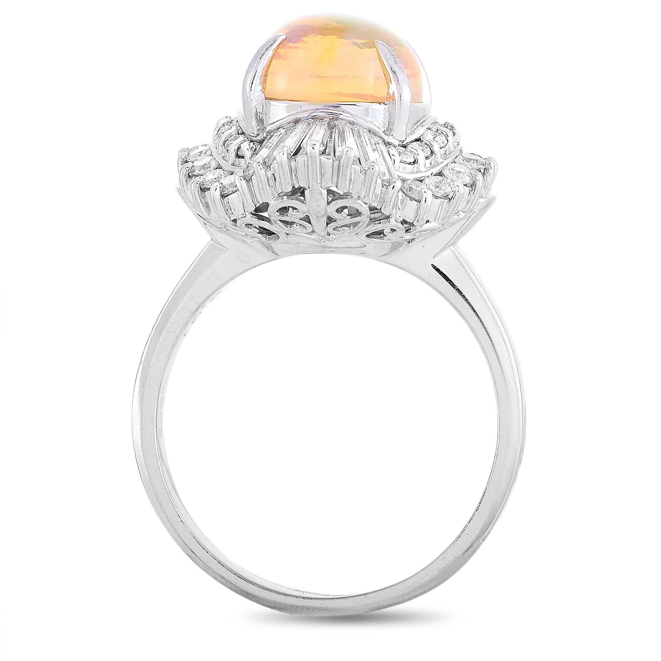 This LB Exclusive ring is made of platinum and embellished with an opal that weighs 3.01 carats and a total of 1.08 carats of diamonds. The ring weighs 11.6 grams and boasts band thickness of 3 mm and top height of 12 mm, while top dimensions