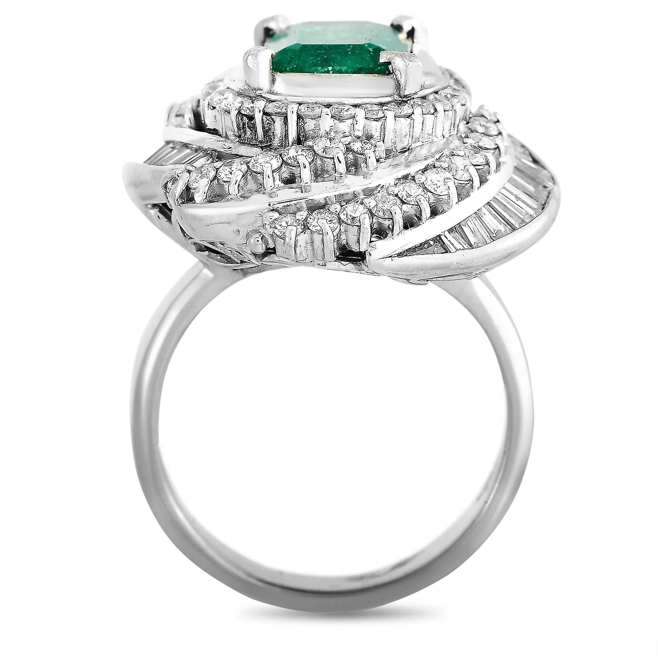 This LB Exclusive ring is crafted from platinum and weighs 17.4 grams, boasting band thickness of 4 mm and top height of 10 mm, while top dimensions measure 22 by 20 mm. The ring is set with a 2.33 ct emerald and a total of 1.79 carats of diamonds.
