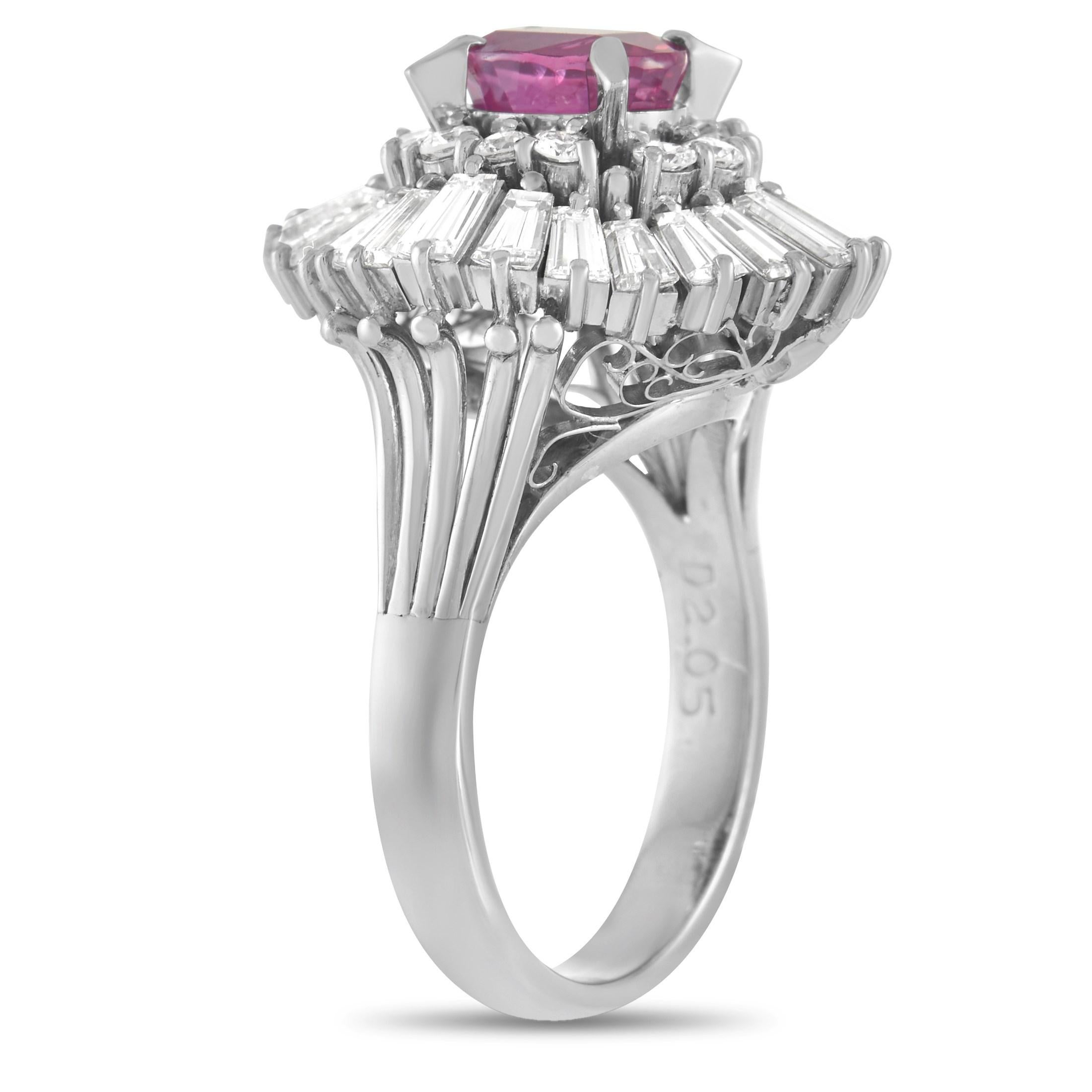 This classic LB Exclusive ring will never go out of style. The band is made with platinum and set with a 2.05 carat halo of round and baguette-cut diamonds. The face of the ring is set with a 1.30 carat oval cut pink sapphire center stone held in