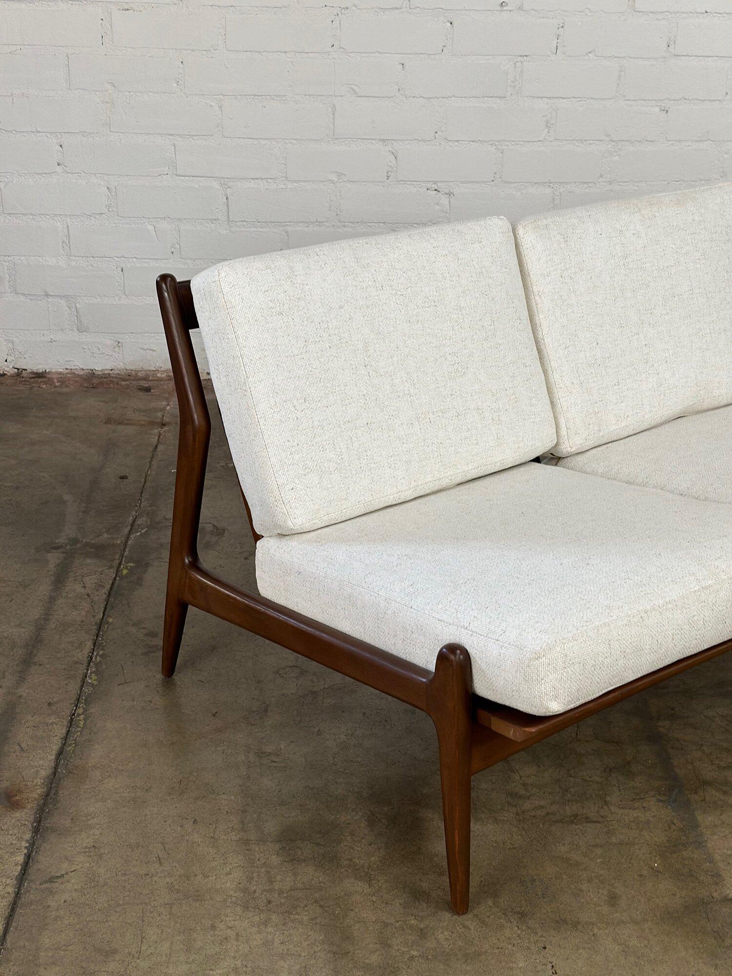 W48 D32 H26.5 SW43 SD20 SH16

In great vintgae condition with newly upholstered seats. This armless loveseat is stamped made in Denmark and is sturdy and sound. Wooden frame was refinished by previous owners and shows very well overall.