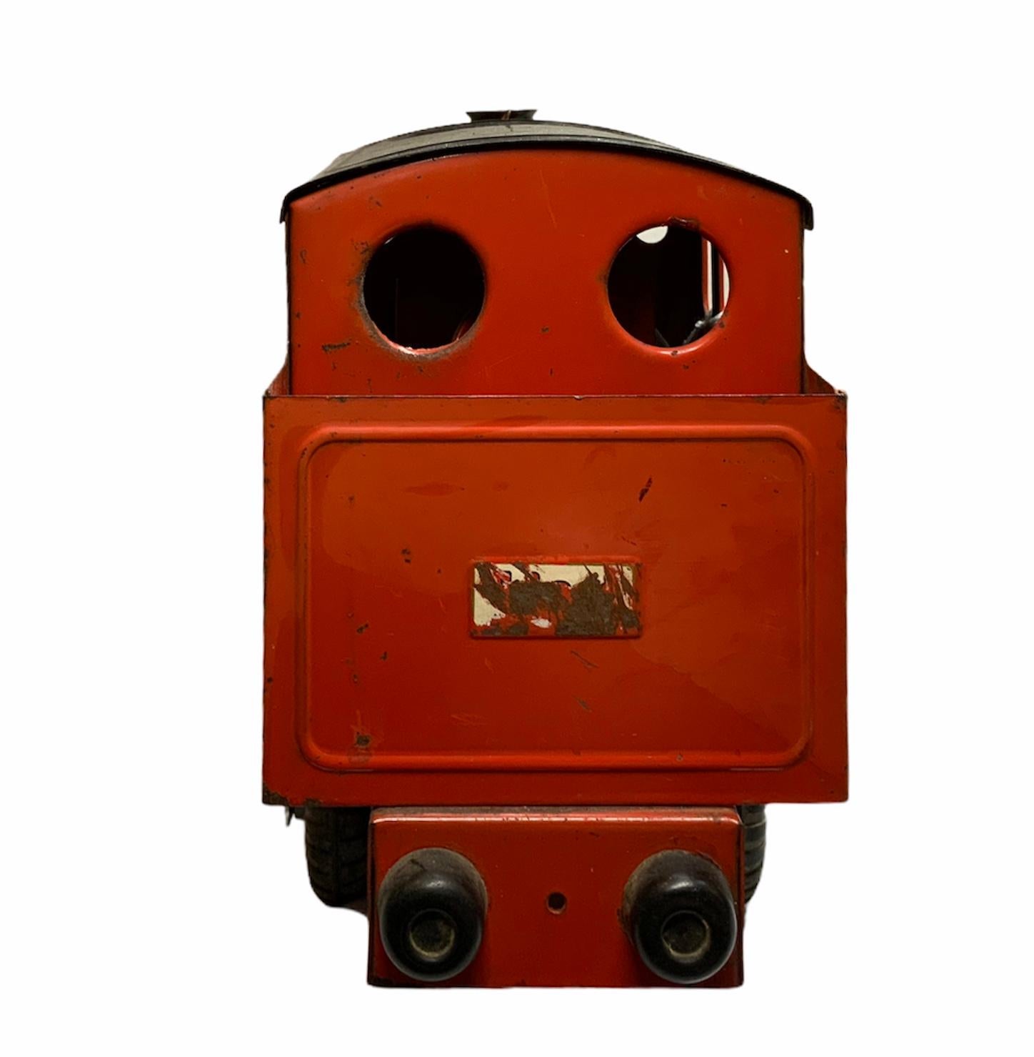 This is a bright orange and black color train-steam locomotives metal toy. It has four black tires and a little silver metal bell in the front top of the driving control cabin.