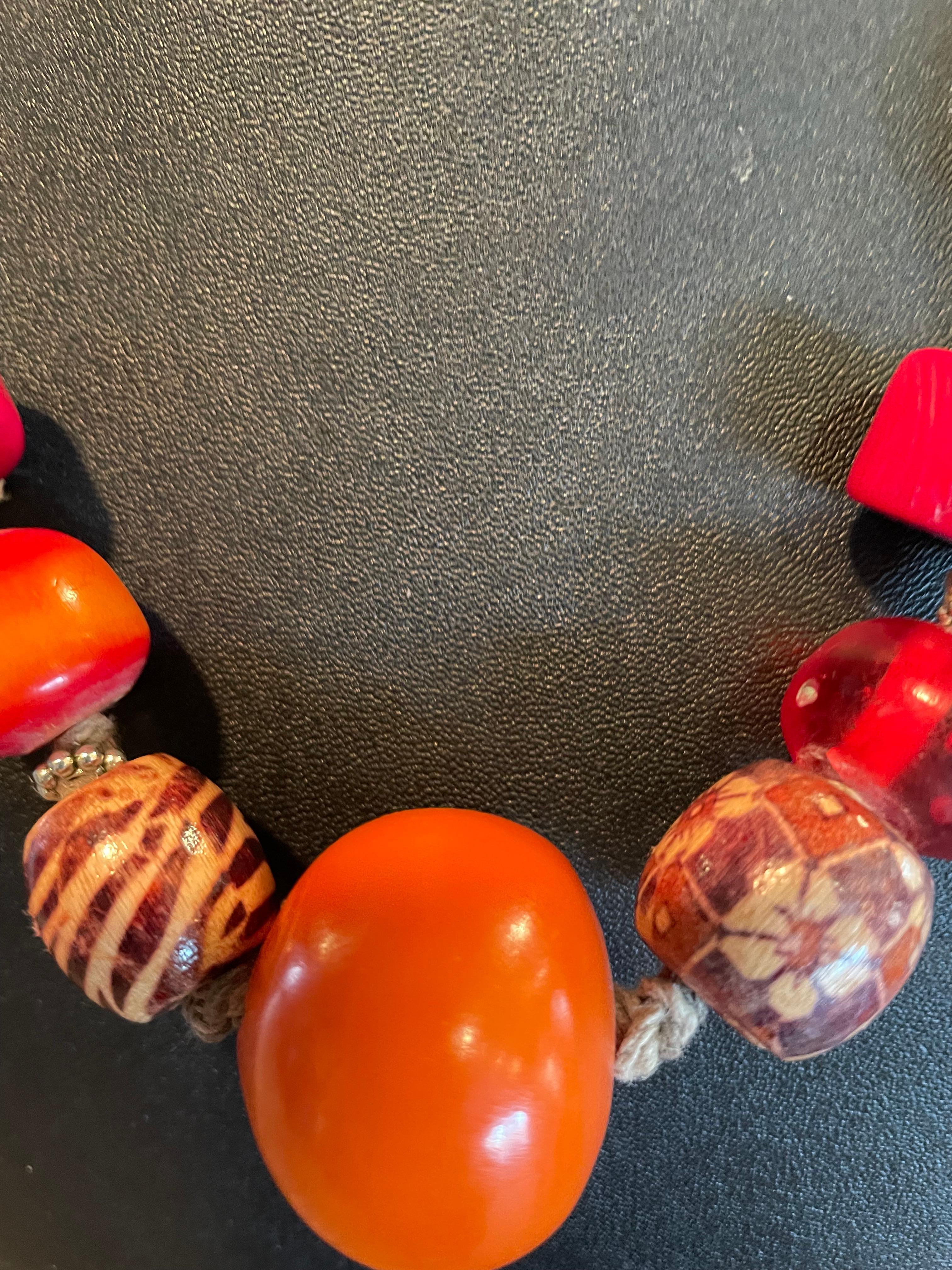 Lorraine’s Bijoux offers a tribal style, one of a kind, handmade, tribal style casual necklace. A selection of Chinese red coral, amber, resin, Tibetan Silver, and hand painted wooden beads, comprise this colorful necklace. These beads are strung on