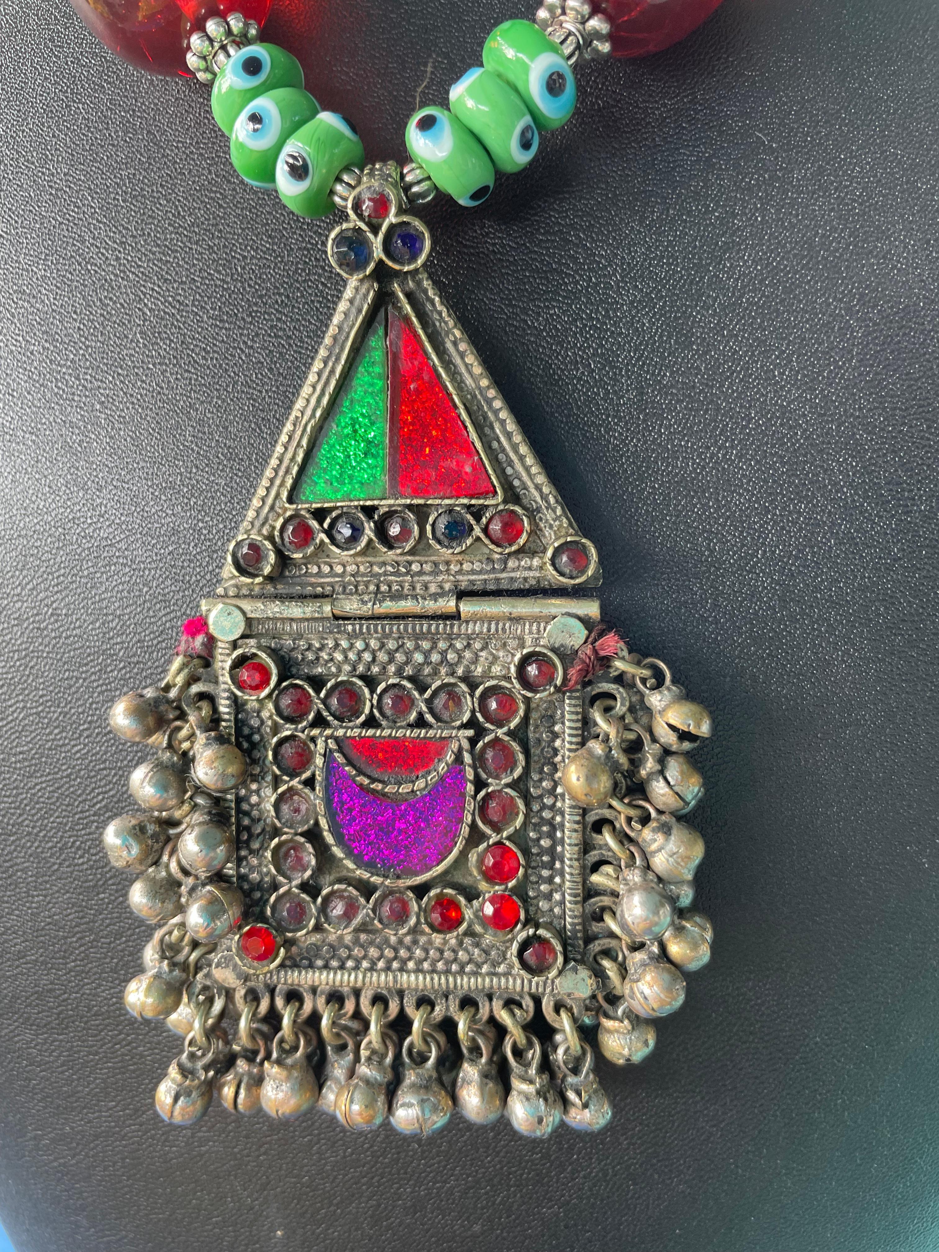 Lorraine’s Bijoux has on offer a Vintage Afghani Enamel and Silver Pendant necklace.
Green glass Venetian beads, Peking glass green beads, Lavender Resin and Silver Indonesian beads, and Red Resin ( Cherry Amber)beads enhance this Stunning pendant.
