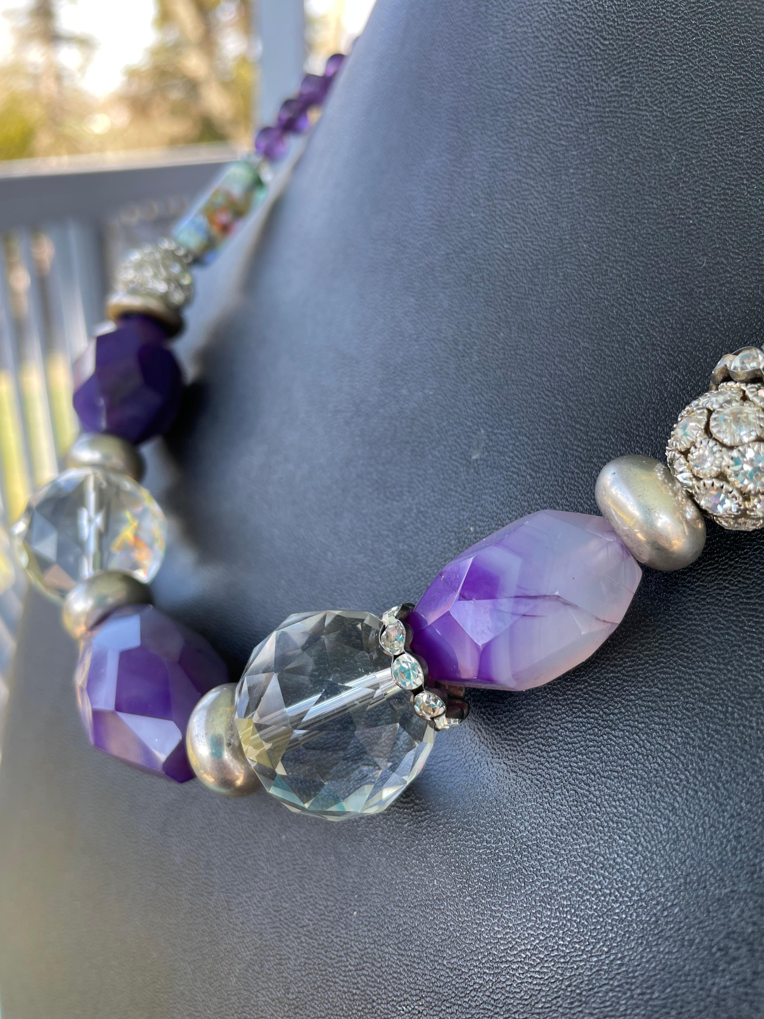 Lorraine’s Bijoux offers a unique ,OOAK, handmade, Beaded necklace of fabulous purple dyed agates, genuine Amethyst and stunning Crystal. This is truly a Statement piece that includes vintage Sterling Silver donut rondelles, inlaid crystal balls,