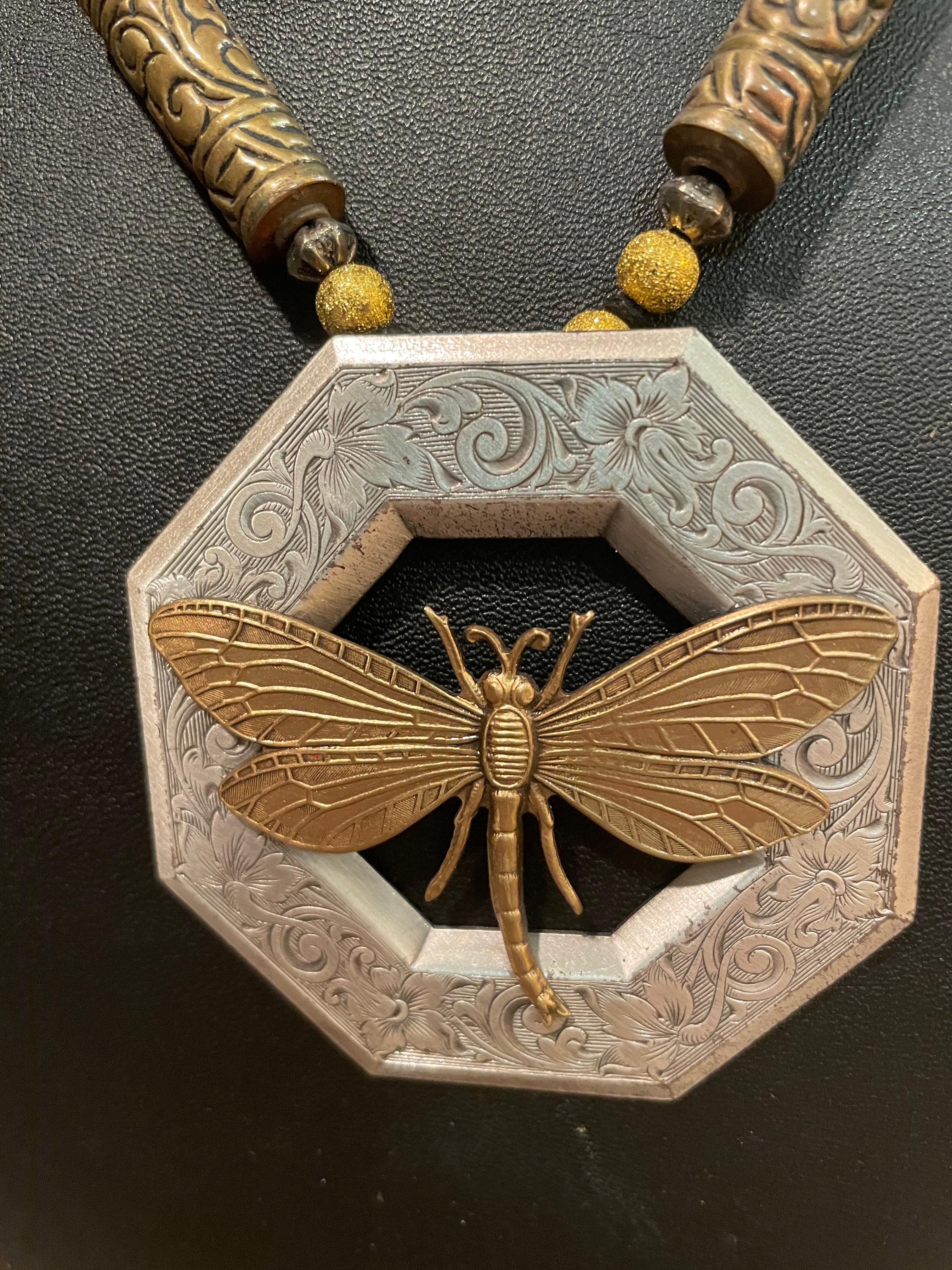LB has on offer a stunning, one of a kind, handmade Antique buckle necklace. A lovely silver dragonfly is centered on the antique Brass buckle and antique silver and brass beads enhance this fabulous piece.
This piece is an outstanding addition to
