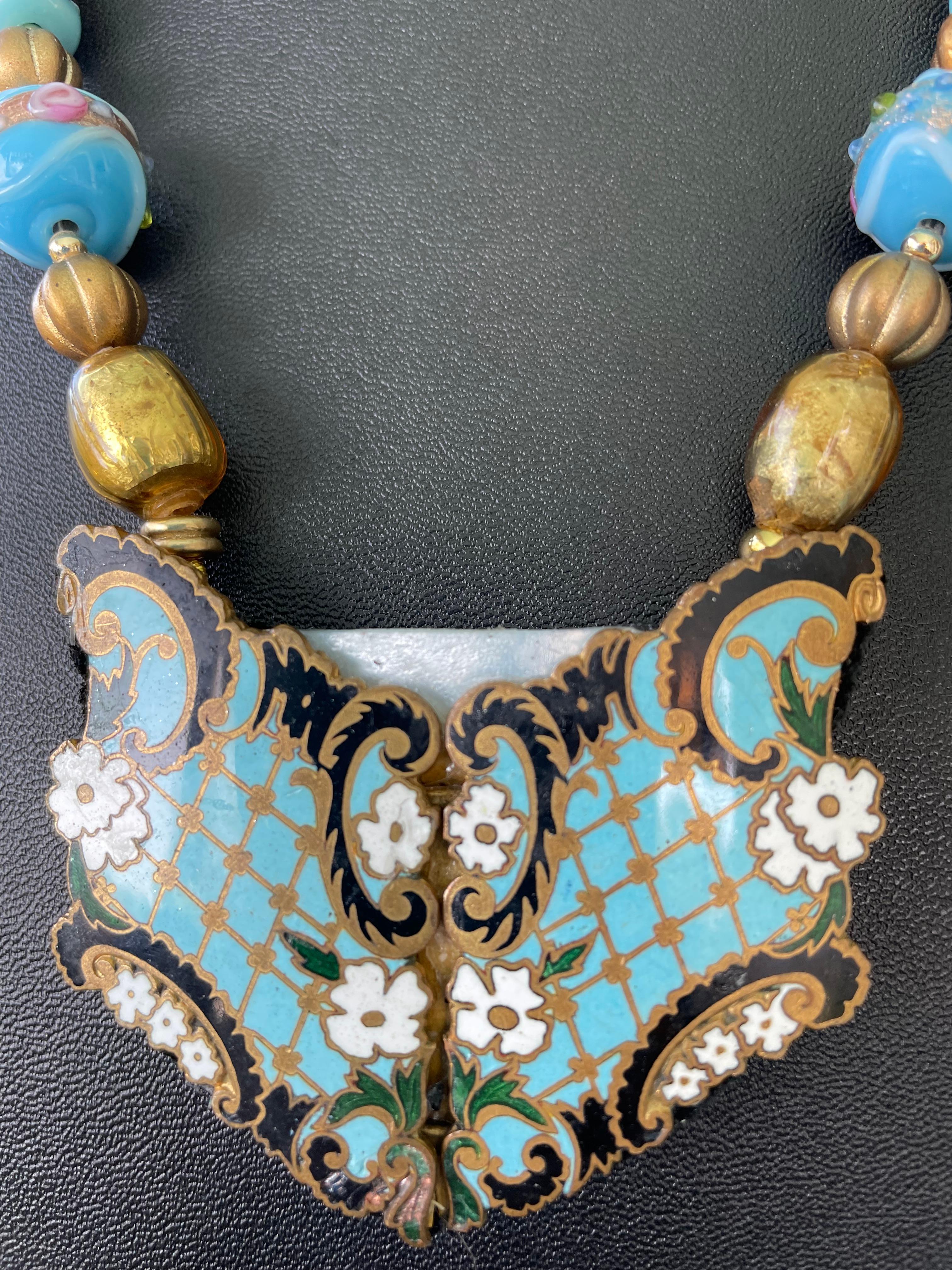Lorraine’s Bijoux has on offer a Vintage Art Nouveau Enamel and Brass French buckle
Pendant necklace. A piece of vintage Mother of Pearl has been added to stabilize the two pieces of the  Buckle and metallic leather has been added to the reverse. 
A
