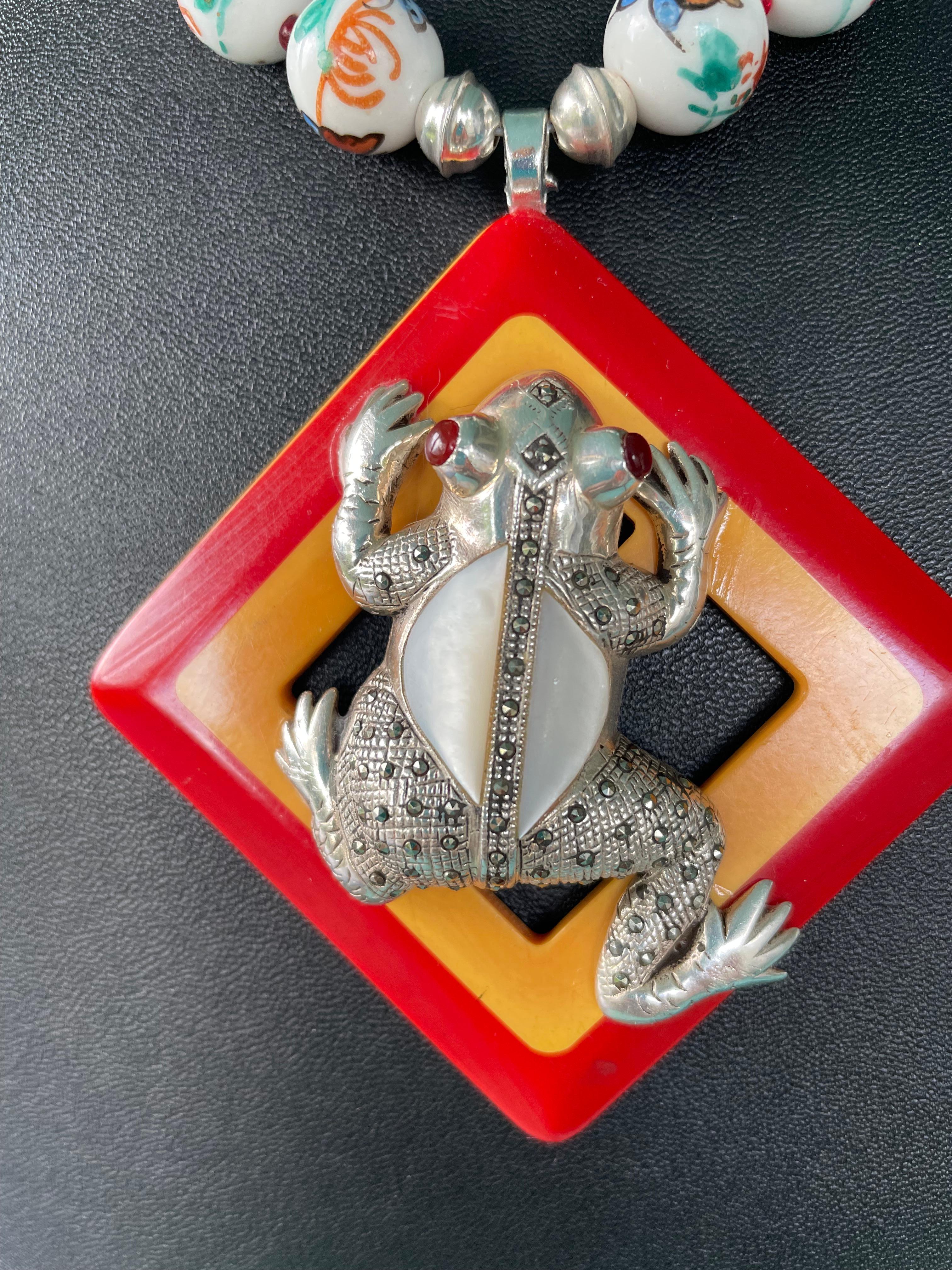 Lorraine’s Bijoux has on offer a Vintage two tone Bakelite Buckle, a vintage Mexican Frog Brooch of Mother of Pearl, Sterling Silver and Marcasite, Tribal multi colored ceramic beads, and Sterling and marcasite tube beads. The colors are amazing and