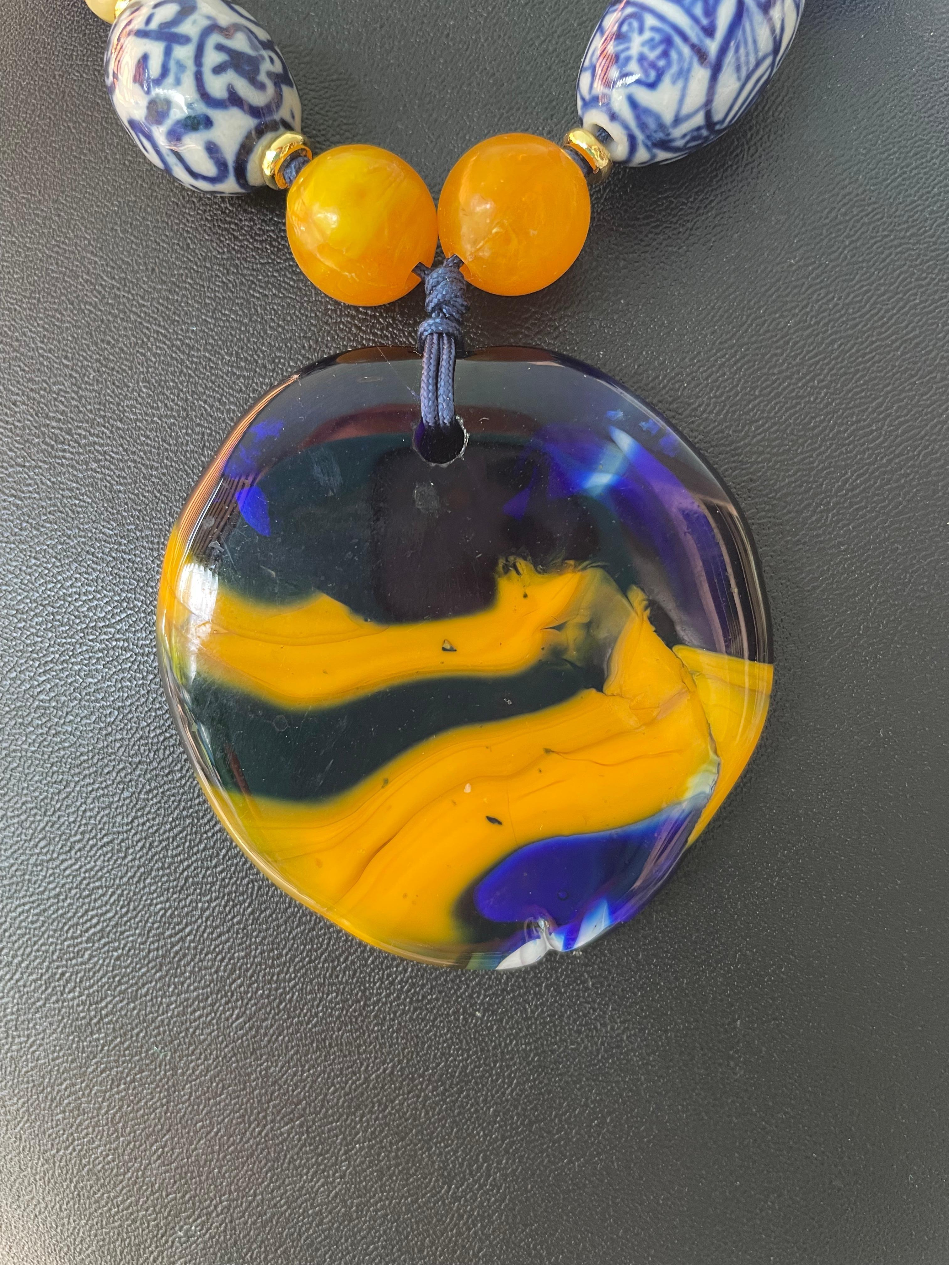 Lorraine’s Bijoux has on offer an Artisan made French Glass pendant from Amboise; France. This piece is one of a kind and has a wonderful combination of colors and the Delft blue and white beads, vintage blue crystals, lapis lazuli squared off 