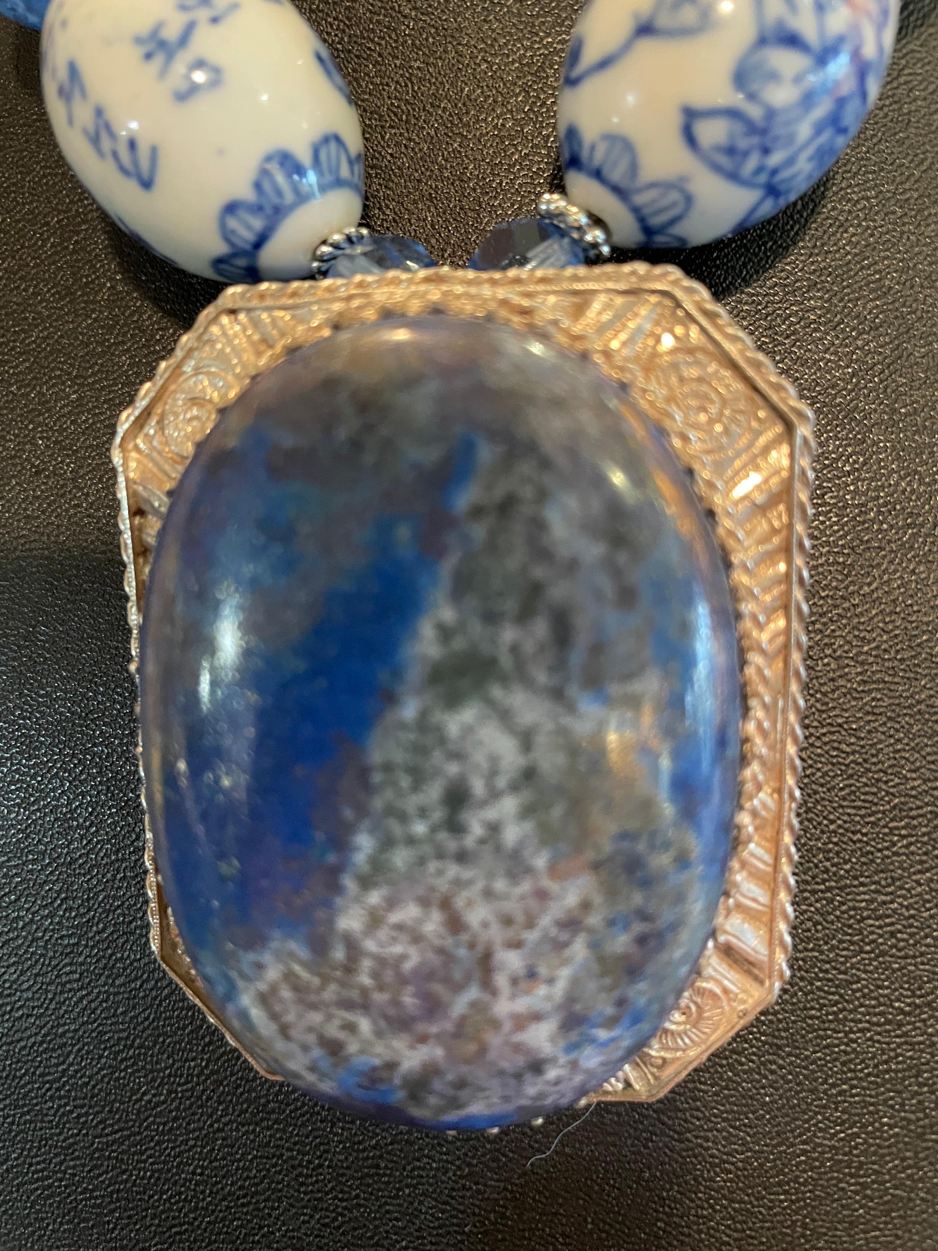 Lorraine’s Bijoux has on offer a Vintage Lapis Lazuli and Sterling Silver pendant from Aphganistan. This necklace is a study in Blues and includes large Blue and White Chinese ceramic beads, Venetian glass variegated beads, blue vintage crystal,