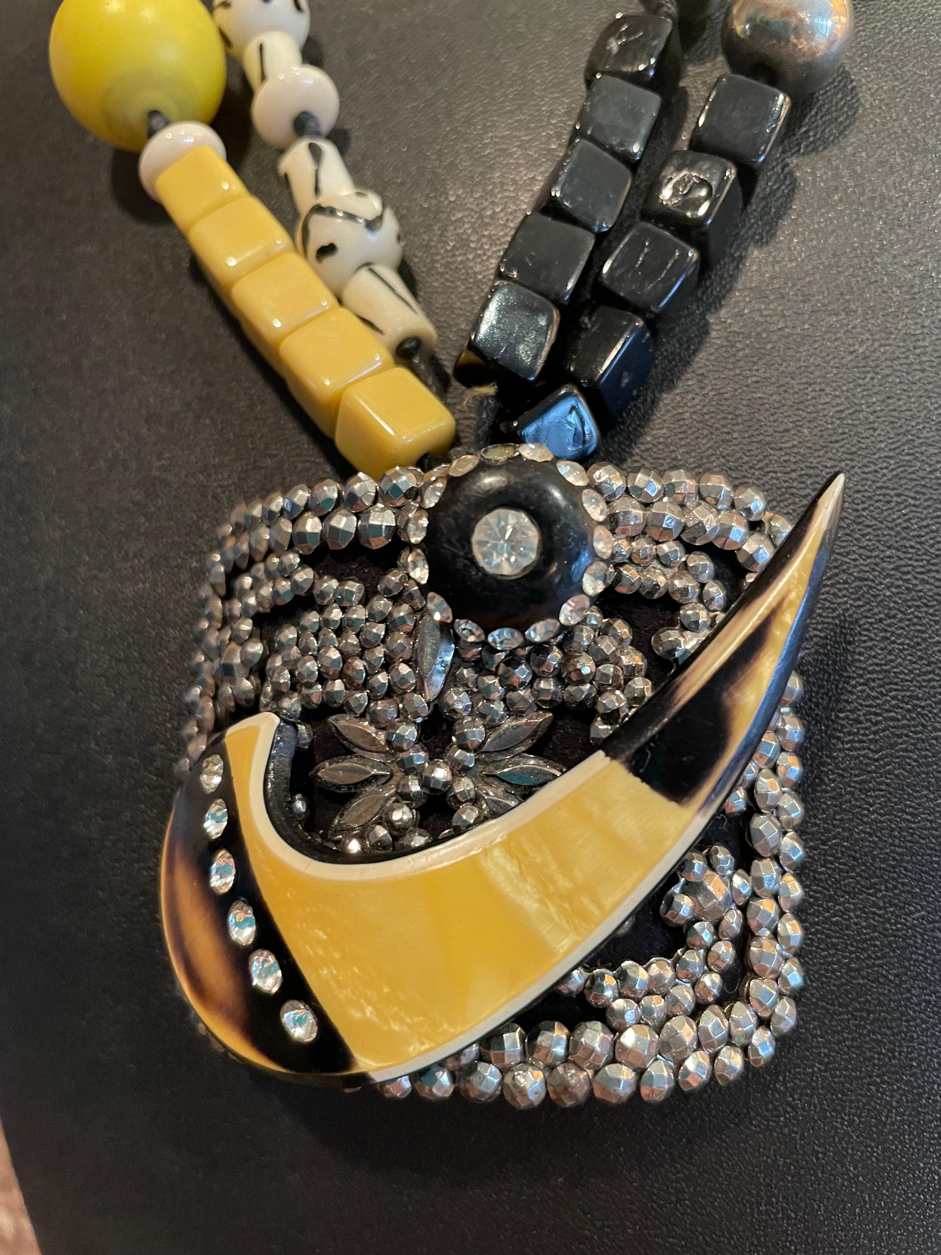 Lorraine’s Bijoux offer’s a magnificent, one of a kind, handmade, Art Deco style, antique French steel buckle, Bakelite, and antique rhinestone button pendant necklace. This page and significant piece is in a class by its’ self. Double strands of