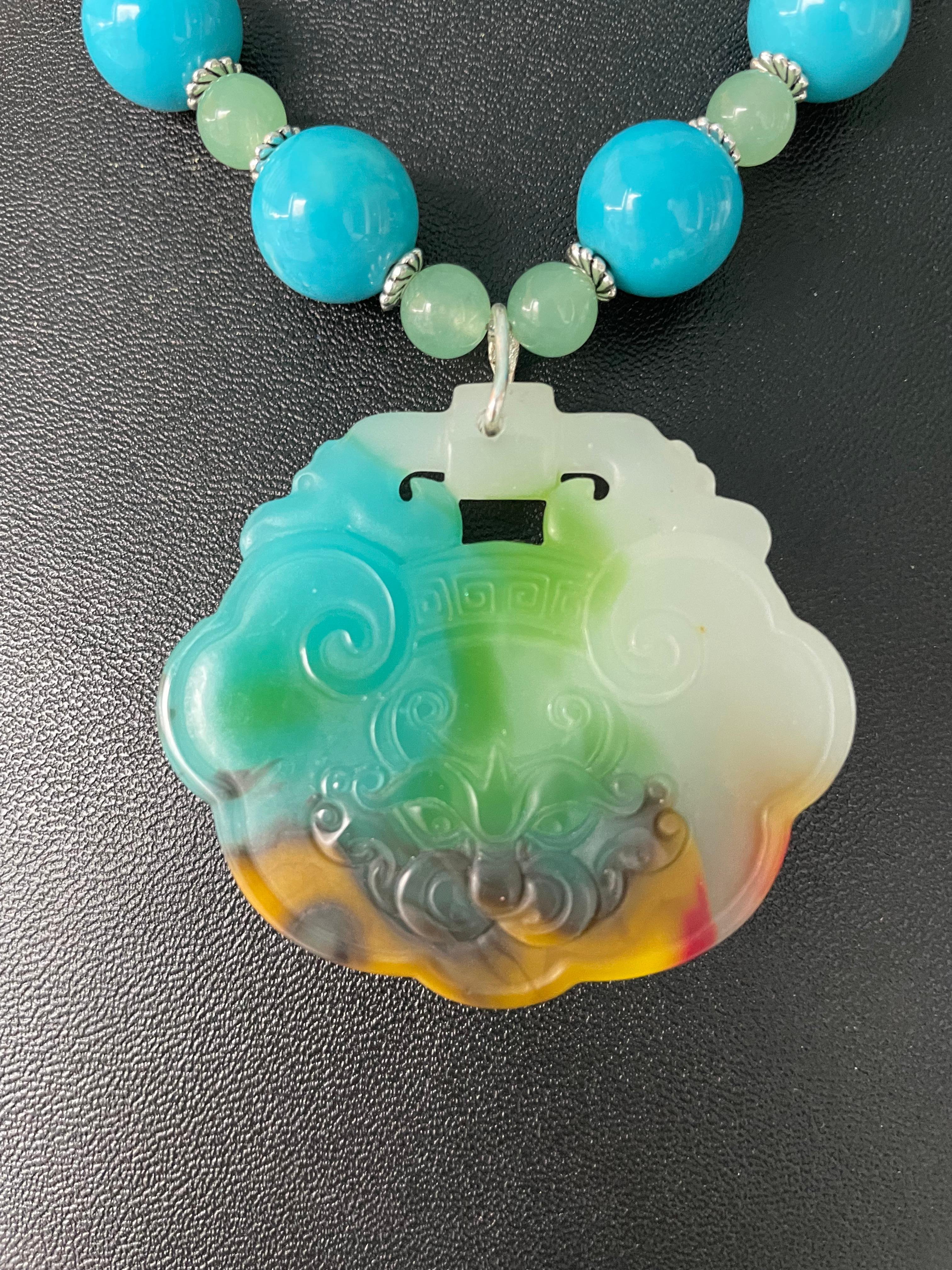 Lorraine’s Bijoux has on offer a Jadeite hand carved Chinese multi colored pendant. The yummy turquoise vintage glass beads and small jadeite green beads add luster and compliment the colors in the pendant. Large agate pieces add interest and