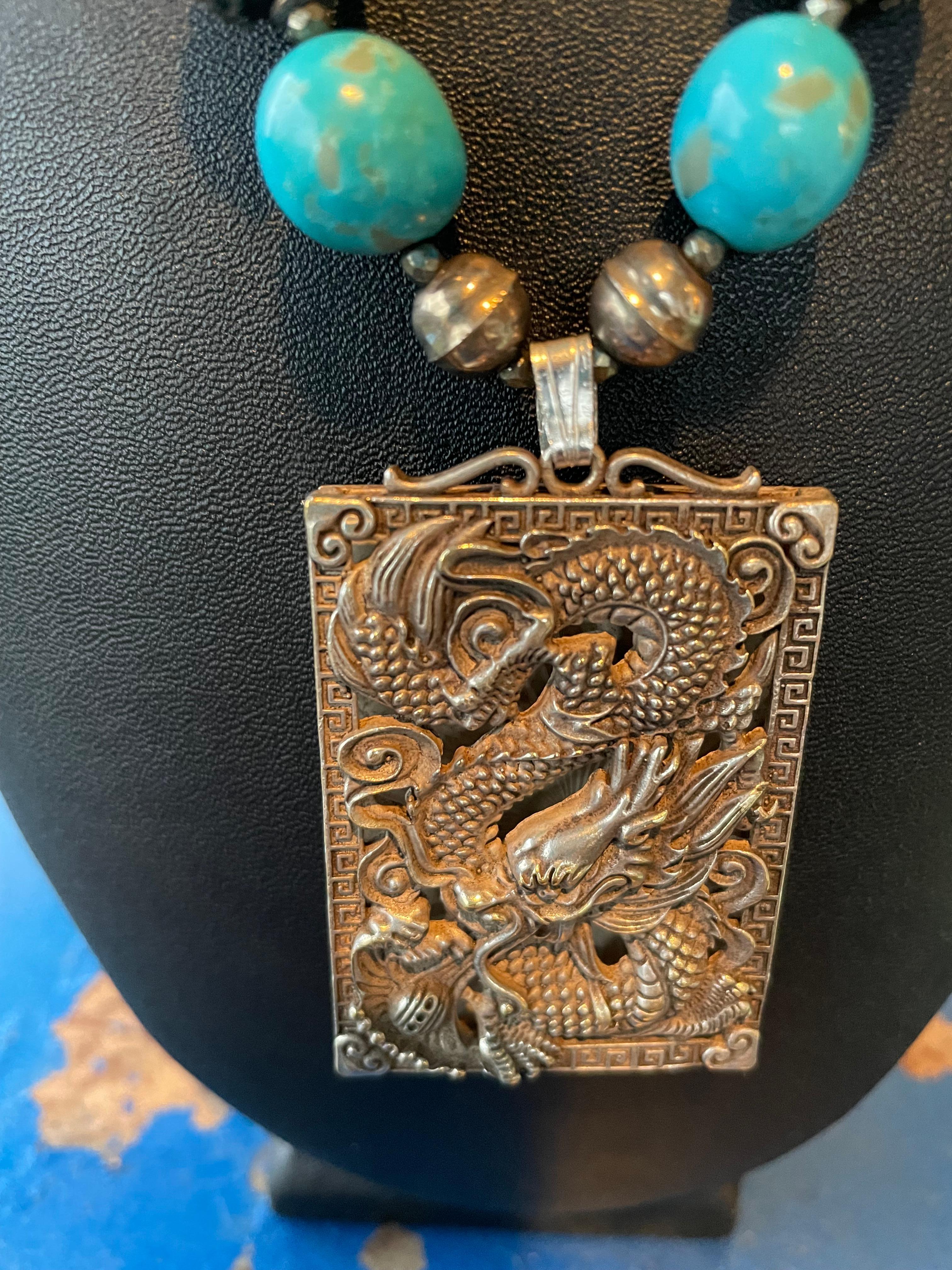 Lorraine’s Bijoux has on offer a large Silver Dragon embossed Chinese Pendant Necklace. Lovely Kingman Mine Turquoise beads, Sterling Silver filigreed beads and Sterling Silver Navajo Pearls and Bronze freshwater pearls add glamour and sparkle. This