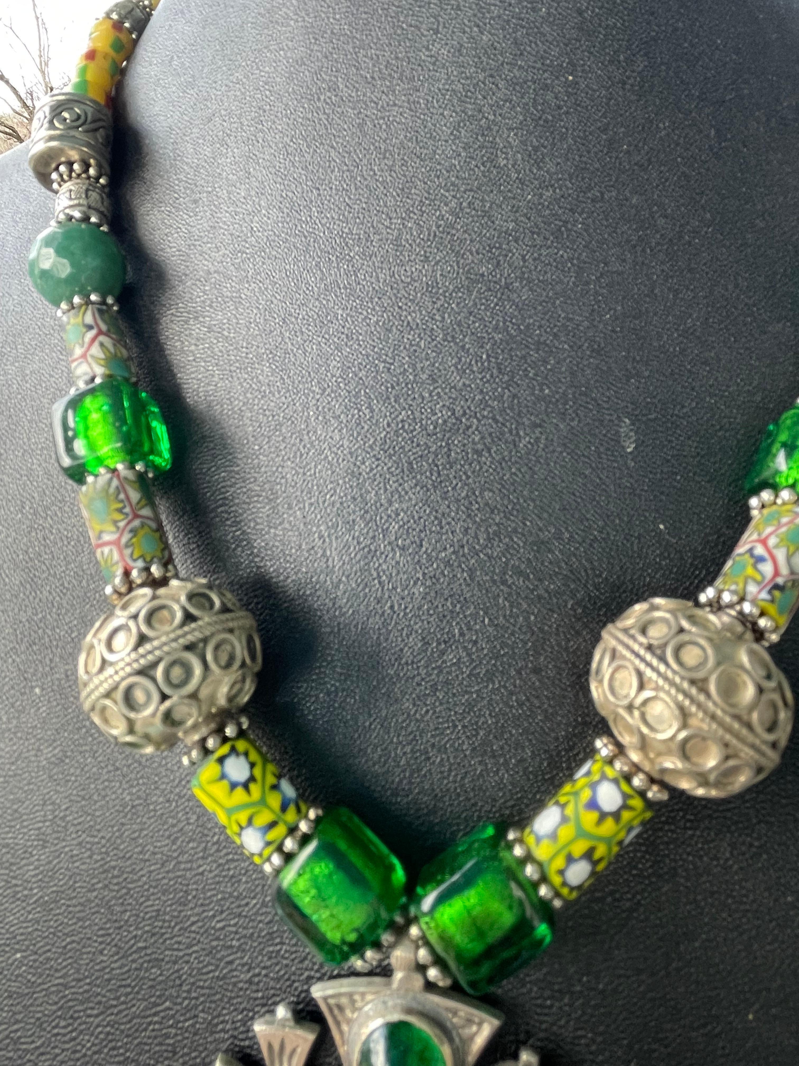 Lorraine’s Bijoux offers a stunning Vintage, Sterling Silver Jerusalem cross with glass cabachons pendant necklace. This wonderful piece also features new green glass Venetian beads, vintage Venetian Mille Fiore beads, Large Tibetan silver beads,