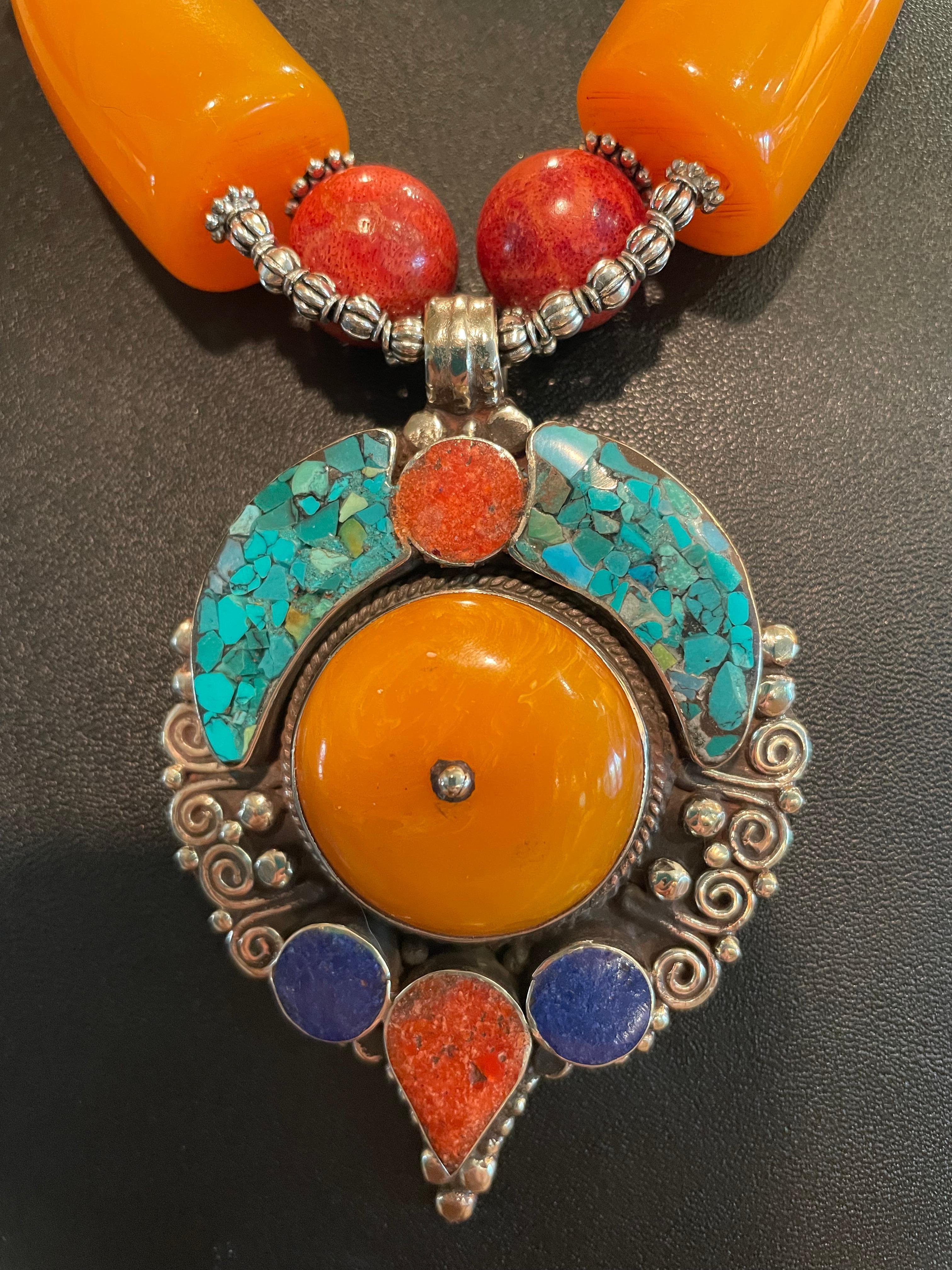 Lorraine’s Bijoux has on offer a large, dramatic inlaid Tibetan Pendant with large stones set in Silver. This pendant is Stunning and has a string of vintage French Amber Bakelite pieces, Tibetan Turquoise and silver beads, Red Sponge Coral, Orange