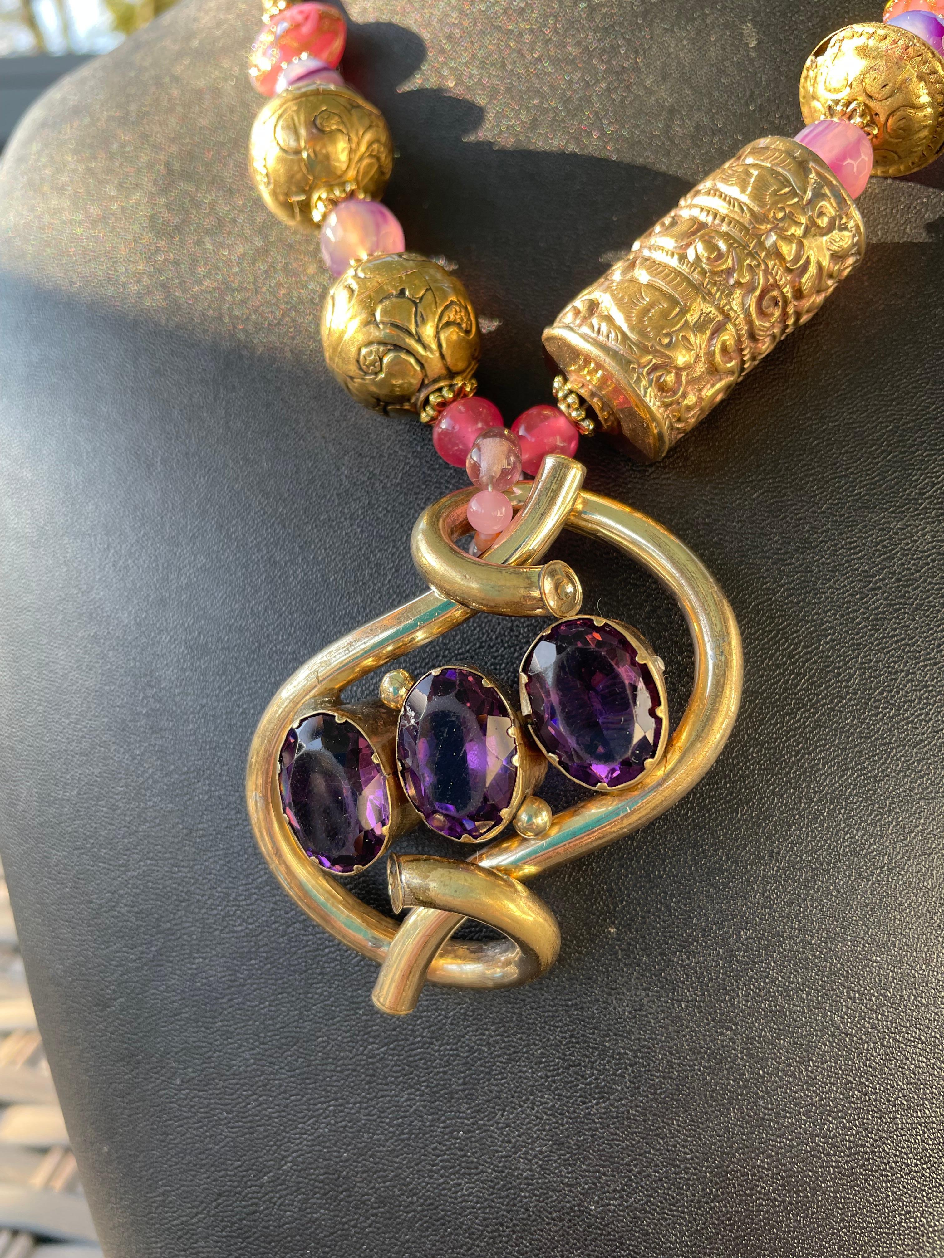 Lorraine’s Bijoux offers a highly unusual 19th century English, goldfilled and Amethyst brooch pendant necklace. This is a wonderful example of Mid Victorian jewelry being repurposed for today’s use. The addition of Tibetan brass beads, agates,