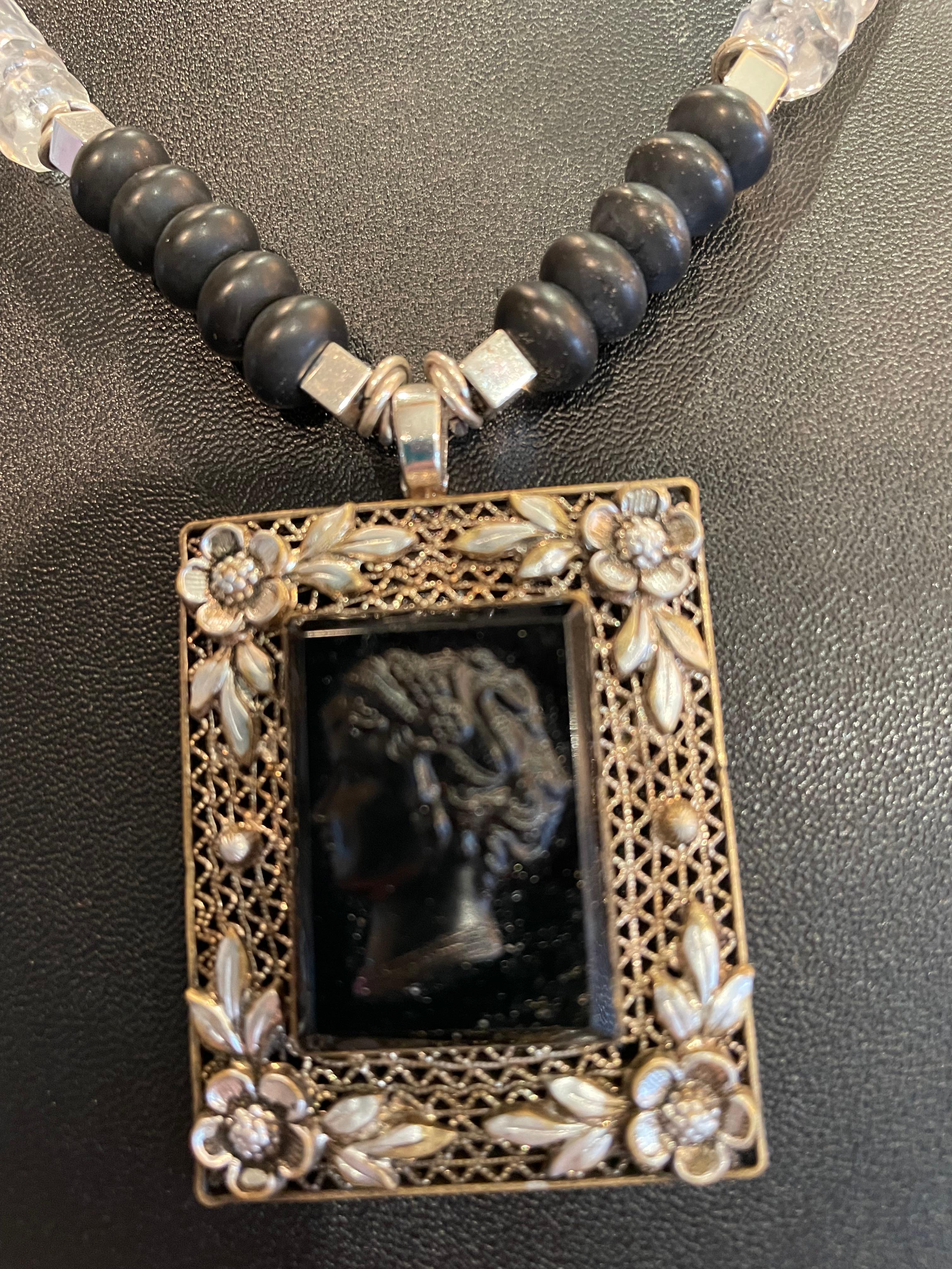 Lorraine’s Bijoux has on offer a Vintage Czech glass and Sterling Silver Cameo pendant necklace. This one of a kind, handmade necklace is unusual and very feminine. The sterling silver filigree work flanking the black glass cameo is very intricate