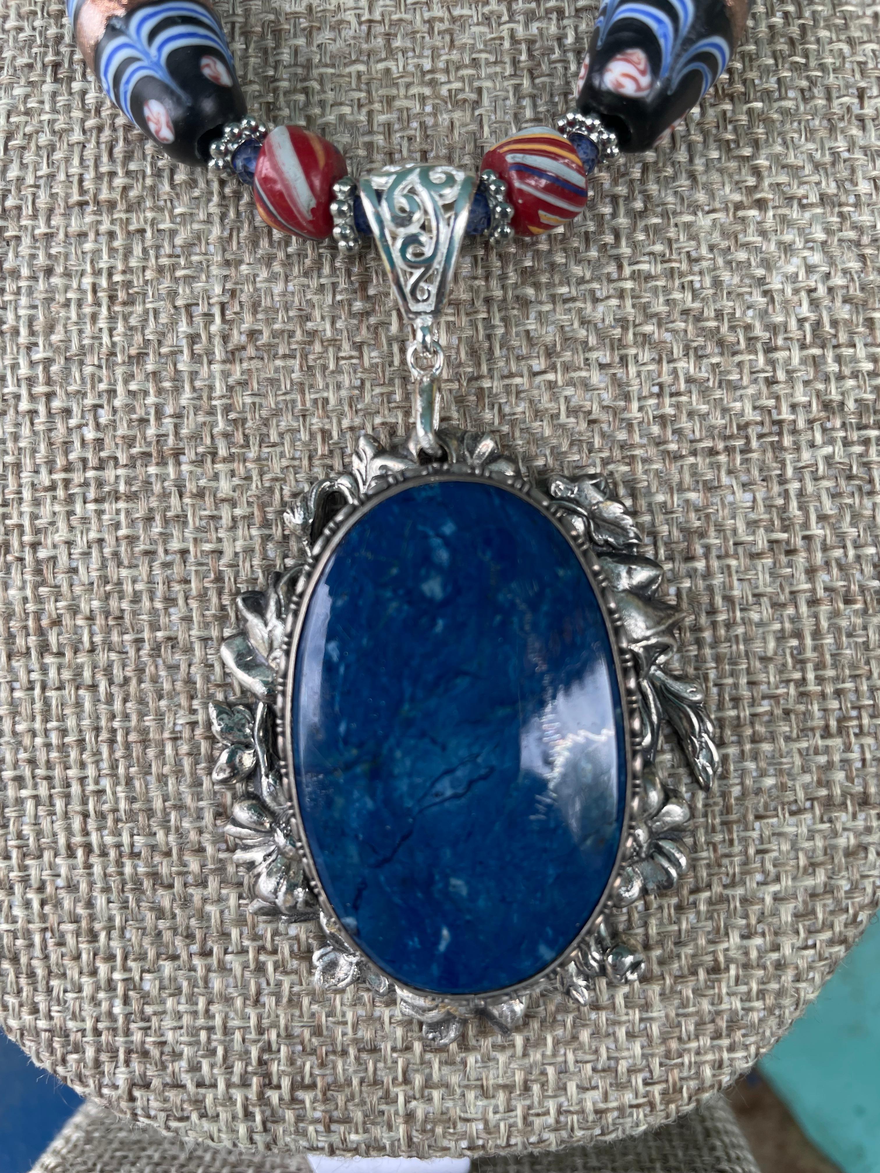 Lorraine’s Bijoux has on offer a Vintage Afghani Lapis Lazuli and Sterling Silver handmade pendant necklace. Vintage Venetian glass beads ,sterling silver spacer beads, and red vintage glass beads enhance this stunning pendant. The Sterling Silver S